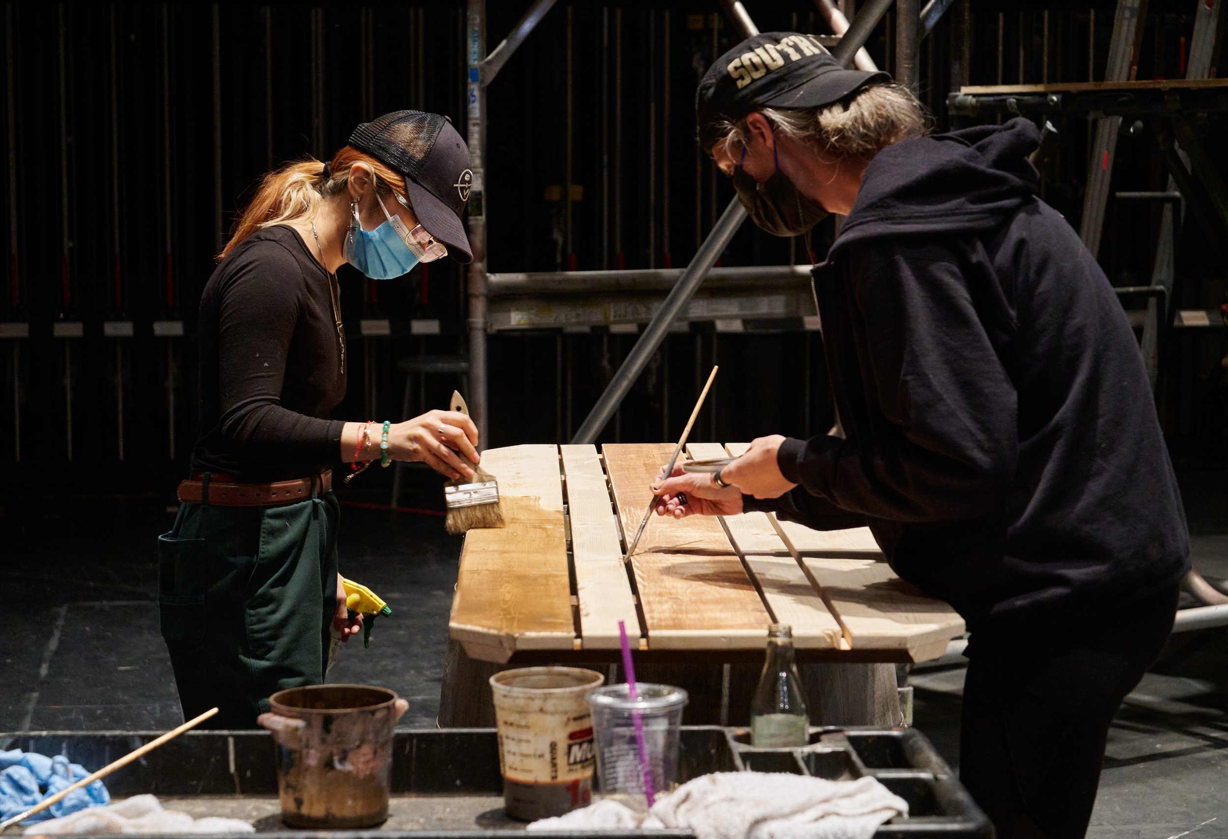  Ashley Montoya and Set Designer  Lacey Anzelc stain a piece of scenery for the Santa Monica College Theatre Arts production of "Treasure Island" in the SMC Main Stage on Tuesday, May 3, 2022, in Santa Monica, Calif. (Nicholas McCall | The Corsair) 