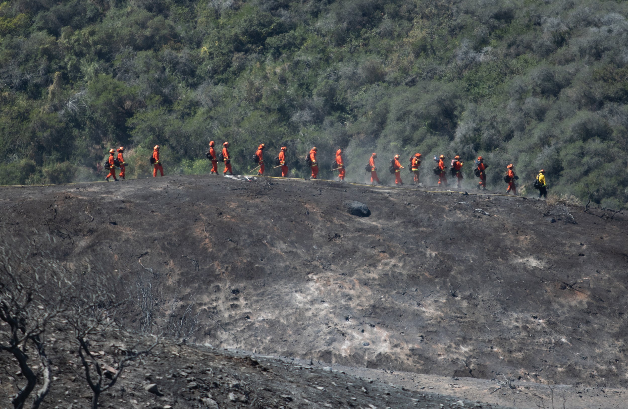 Incarcerated Firefighters walking down to hill to help mitigate any hotspots on Fri. May 13, 2022 at Laguna Niguel, Calif. (Danilo Perez | The Corsair) 