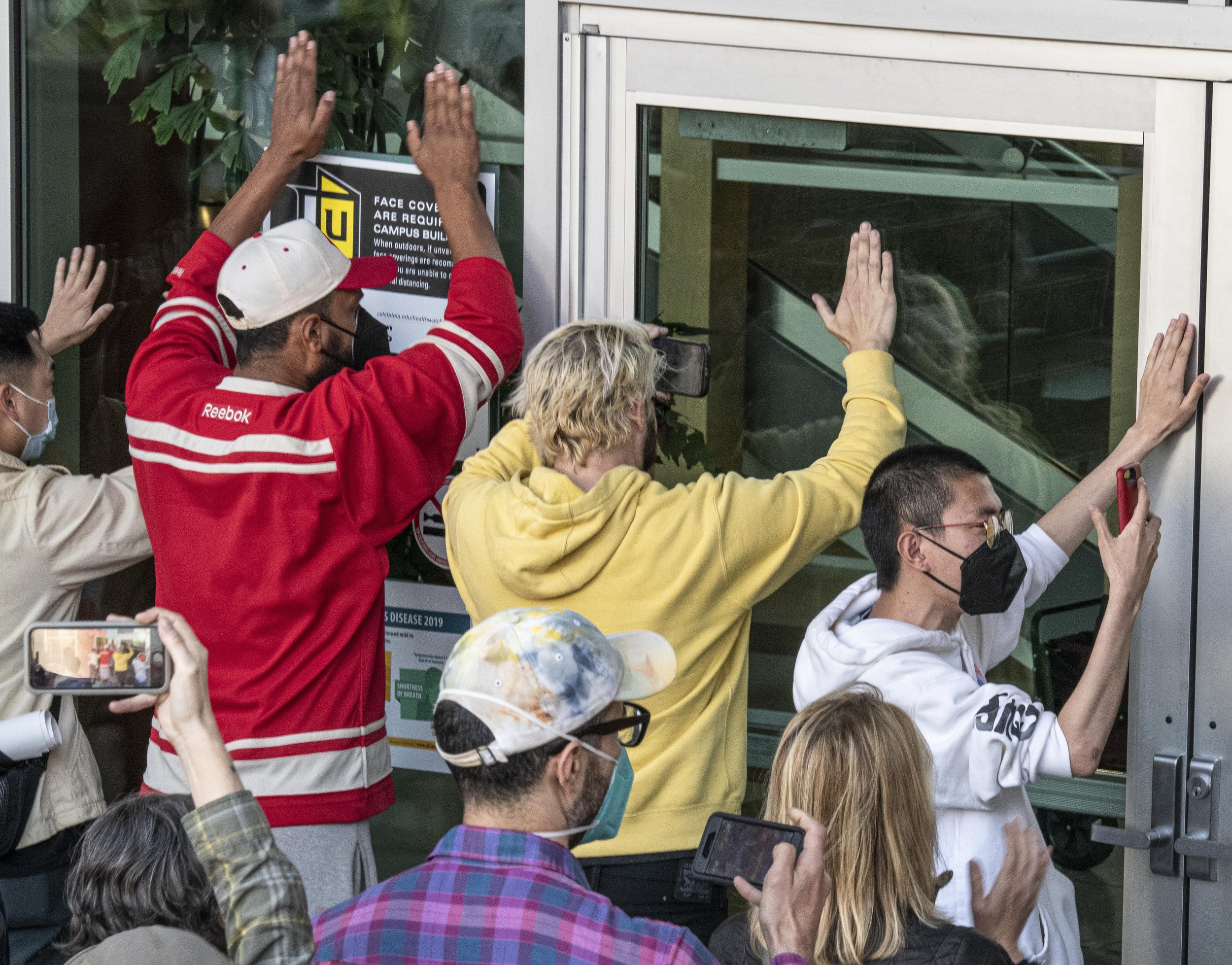  Protestors outside the University Student Union bang on the windows of the building as they are locked out of the current Mayoral debate taking place with only a very limited select few participants allowed in on Sunday May 1, 2022 at the Mayoral de