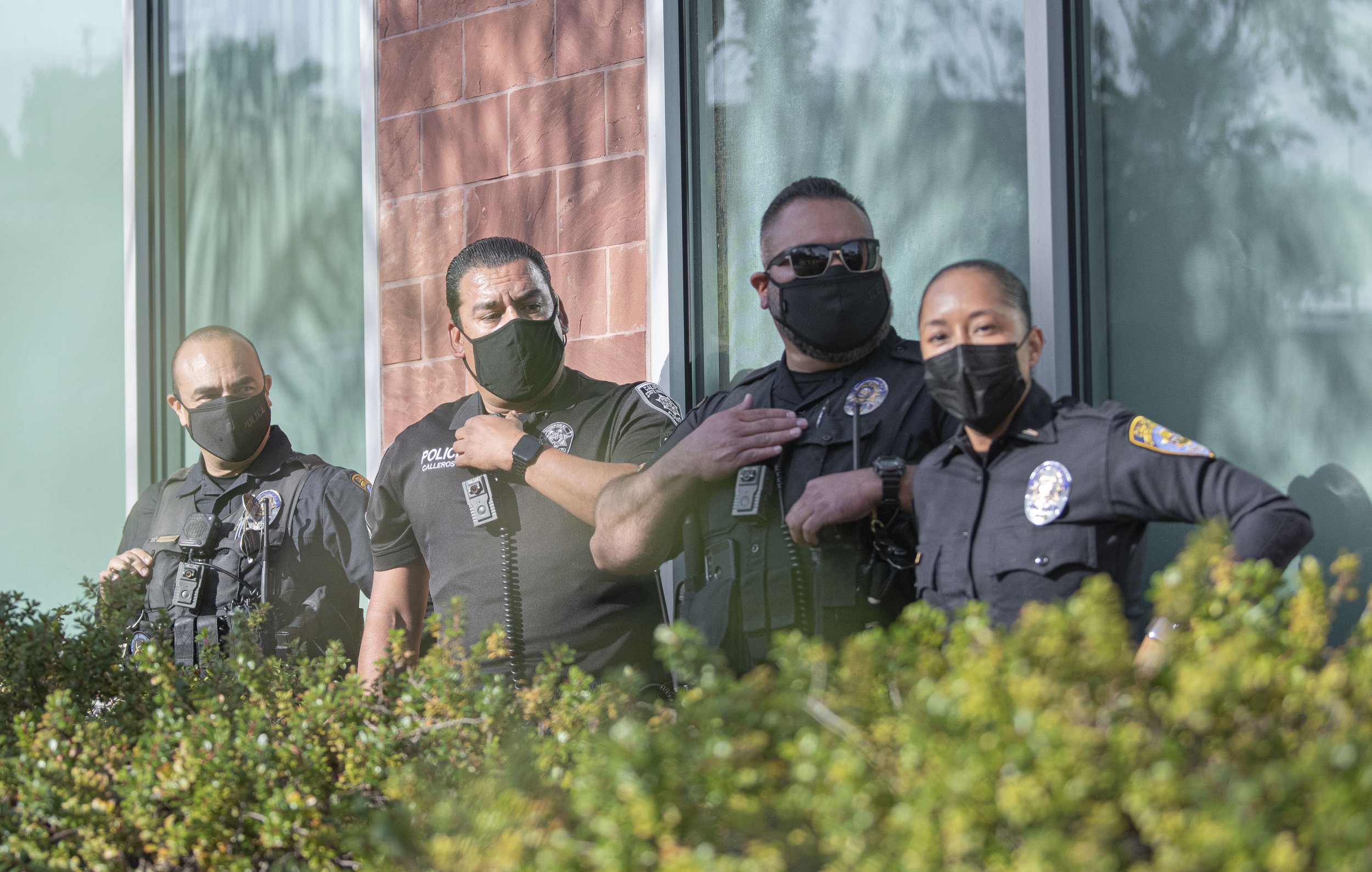  Cal State University Police officers are forced to retreat behind the building where the debate was being held after protestors retrieved Melanie Abdullah out of police possession after being removed for trespassing on Sunday May 1, 2022 at the Mayo