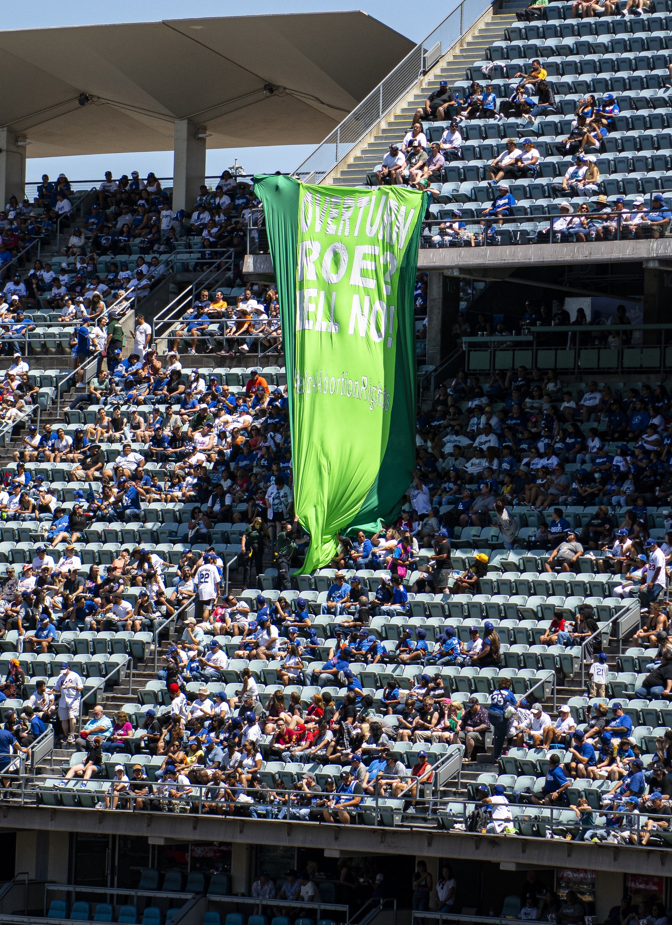  Rise Up for Abortion Rights members unfurl a large "Overturn Roe Hell No" banner during the 1:00 game vs. the New York Mets at Dodger Stadium Sunday, June 5. (Jon Putman | The Corsair) 