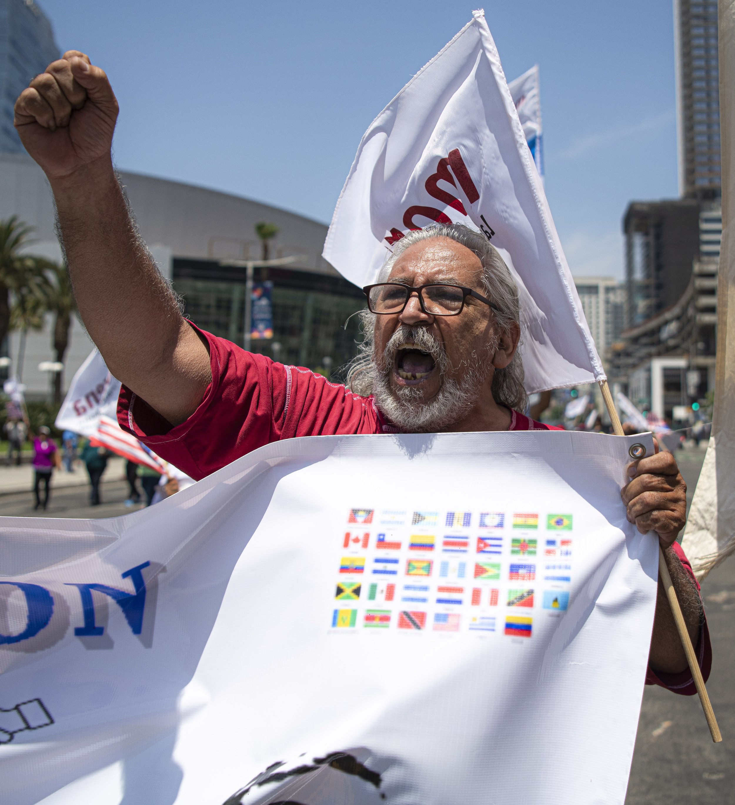  A protestor for the Latin America protest marchs towards the front gates of the Convention Center in downtown Los Angeles. (Jon Putman | The Corsair) 