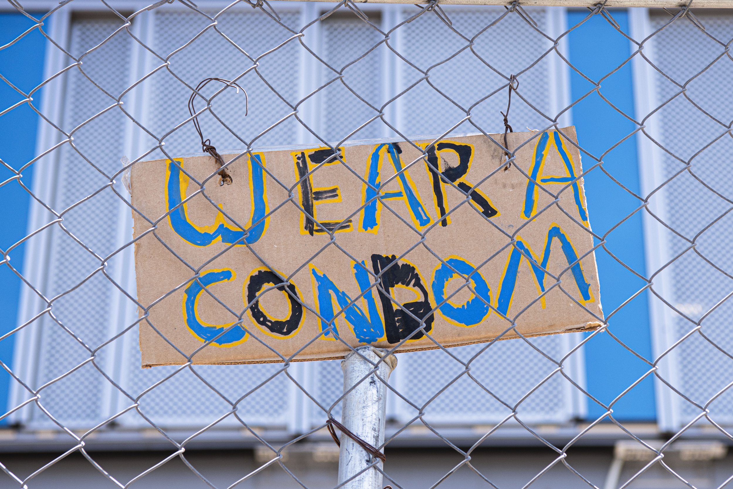  Construction workers from a nearby construction site place a sign for the Abortion members protesting outside of the 9th Annual Summit of Americas. (Jon Putman | The Corsair) 