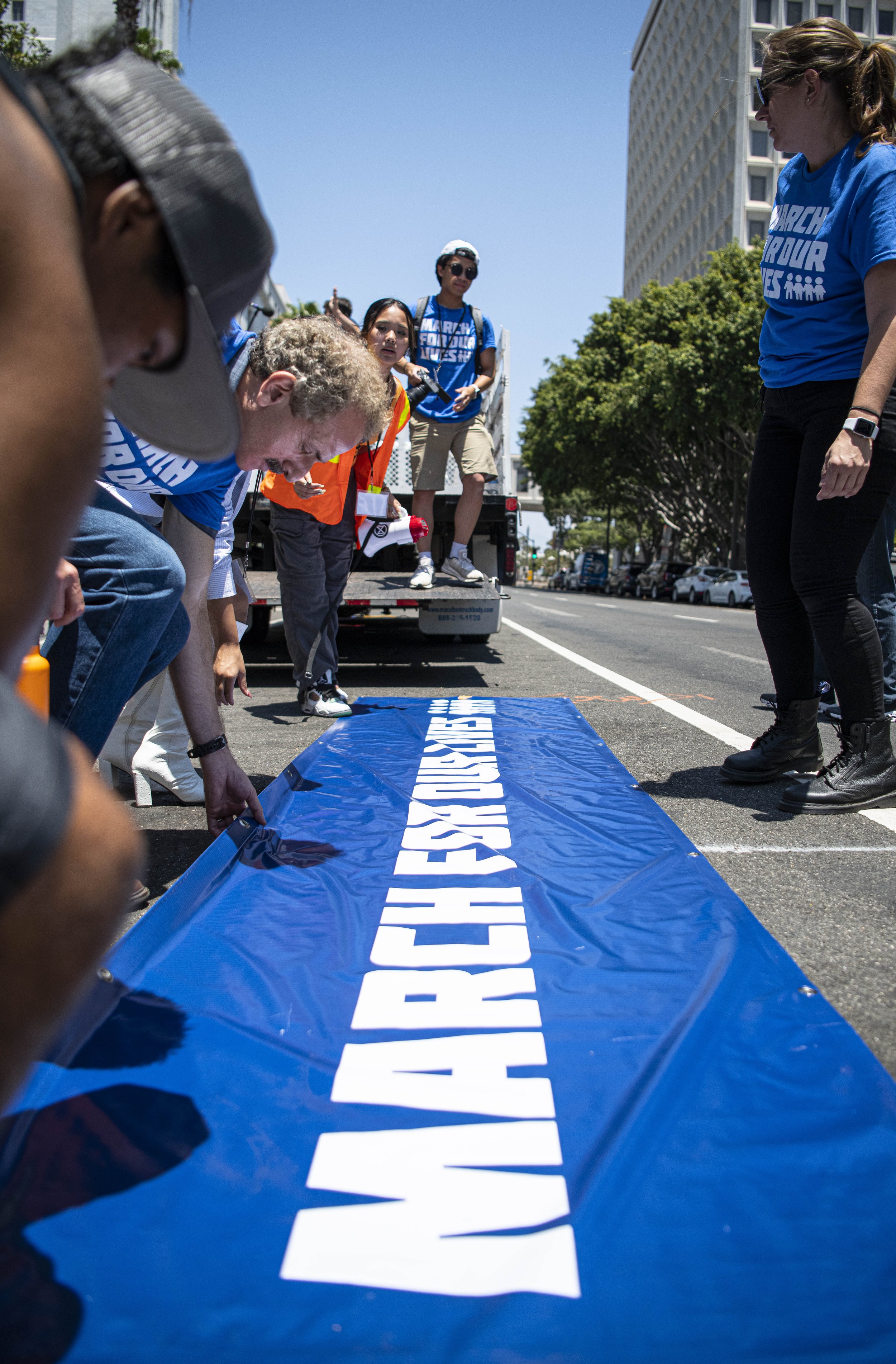  March for our lives supporters ready the banner that will be used in the peaceful protest in the streets of downtown Los Angeles. (Jon Putman | The Corsair) 