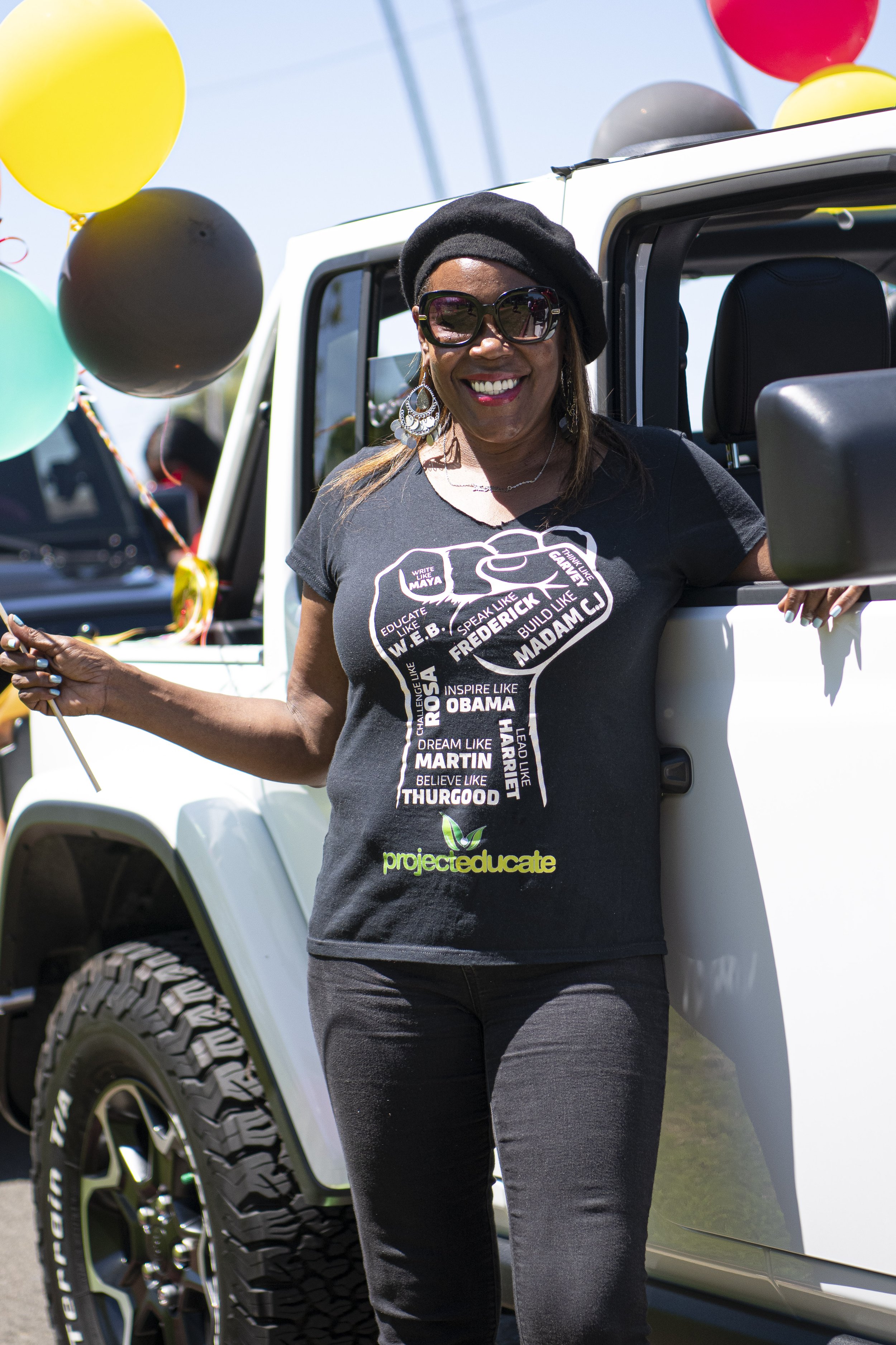  A participant in the Juneteenth parade stands by her decorated Jeep Wrangler before the parade begins. (Jon Putman | The Corsair) 