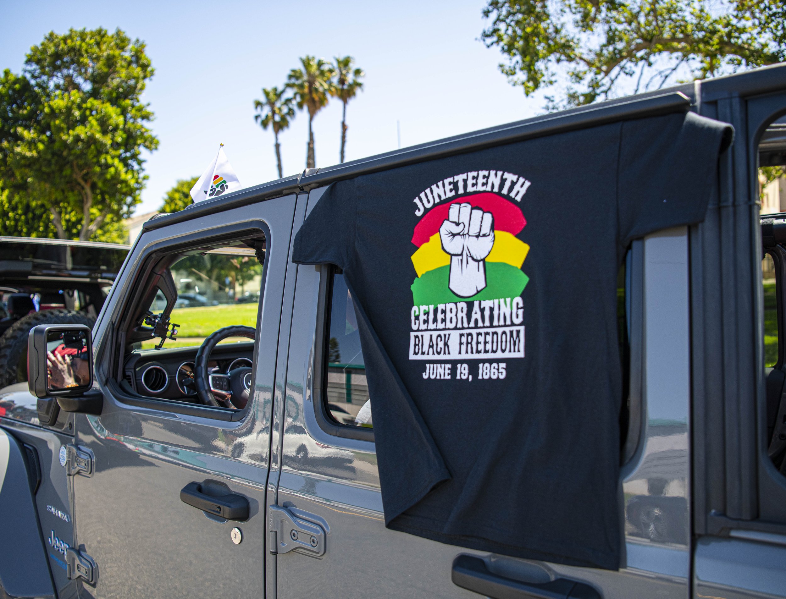  A Juneteenth shirt made for the new federal holiday is displayed on one of the jeeps that will be used in the parade. (Jon Putman | The Corsair) 