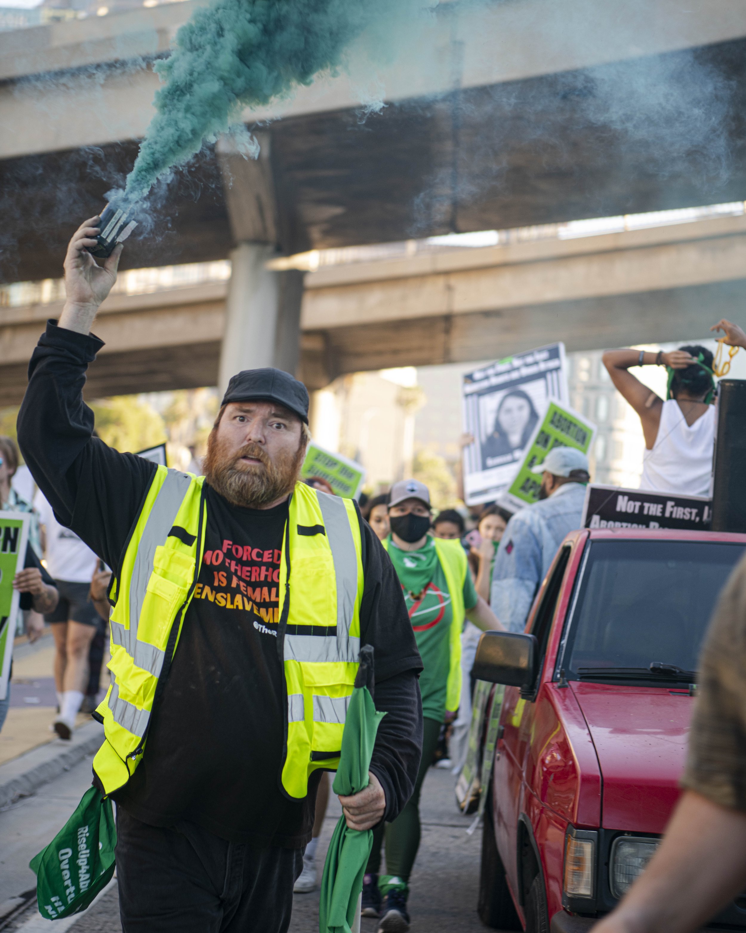  Protester hold green smoke grenade at abortion rally (Jon Putman | The Corsair) 