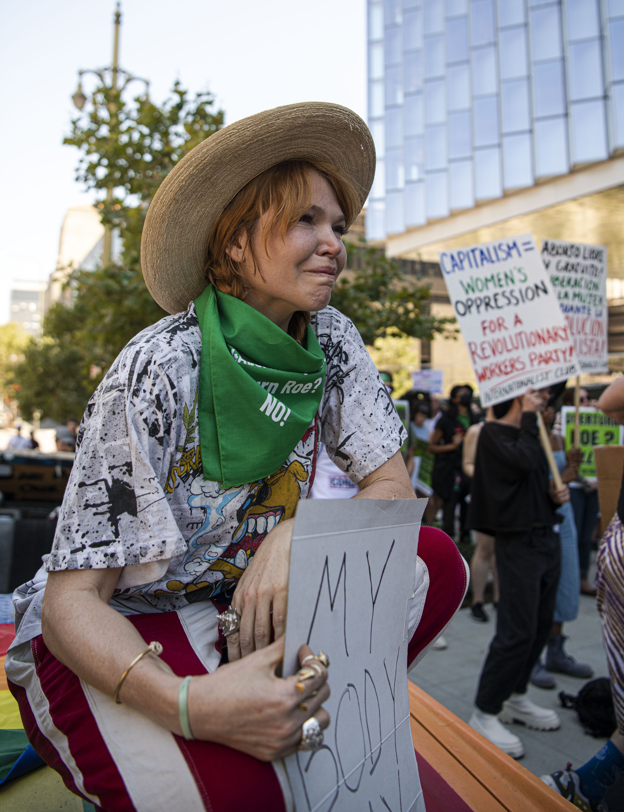  Eleanor Wells sits after listening to a story someone is sharing at the rally for abortion rights. (Jon Putman | The Corsair) 