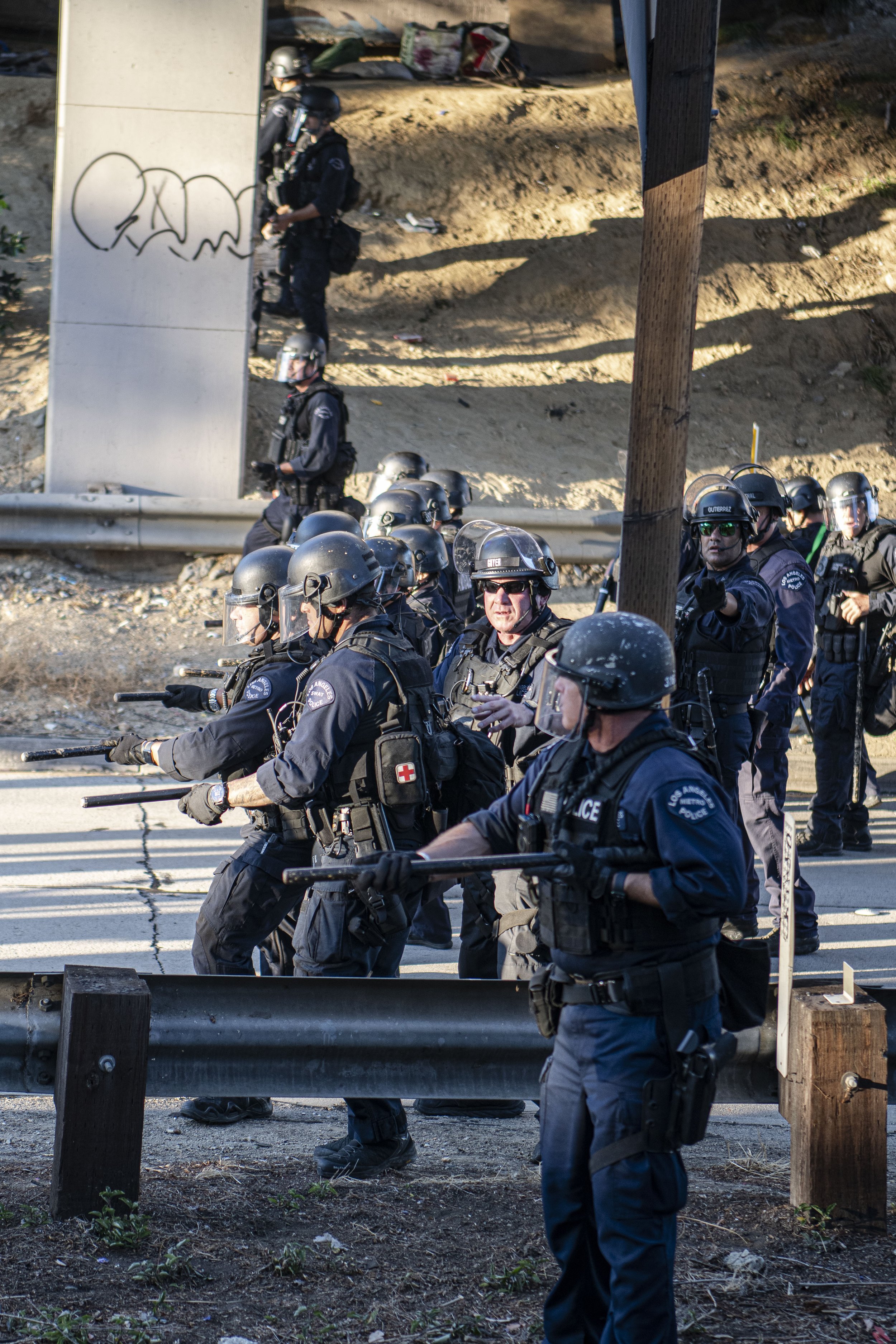  LAPD officers in full riot gear form a barrier line forcing the Abortion rights rally off the 110 Freeway. (Jon Putman | The Corsair) 