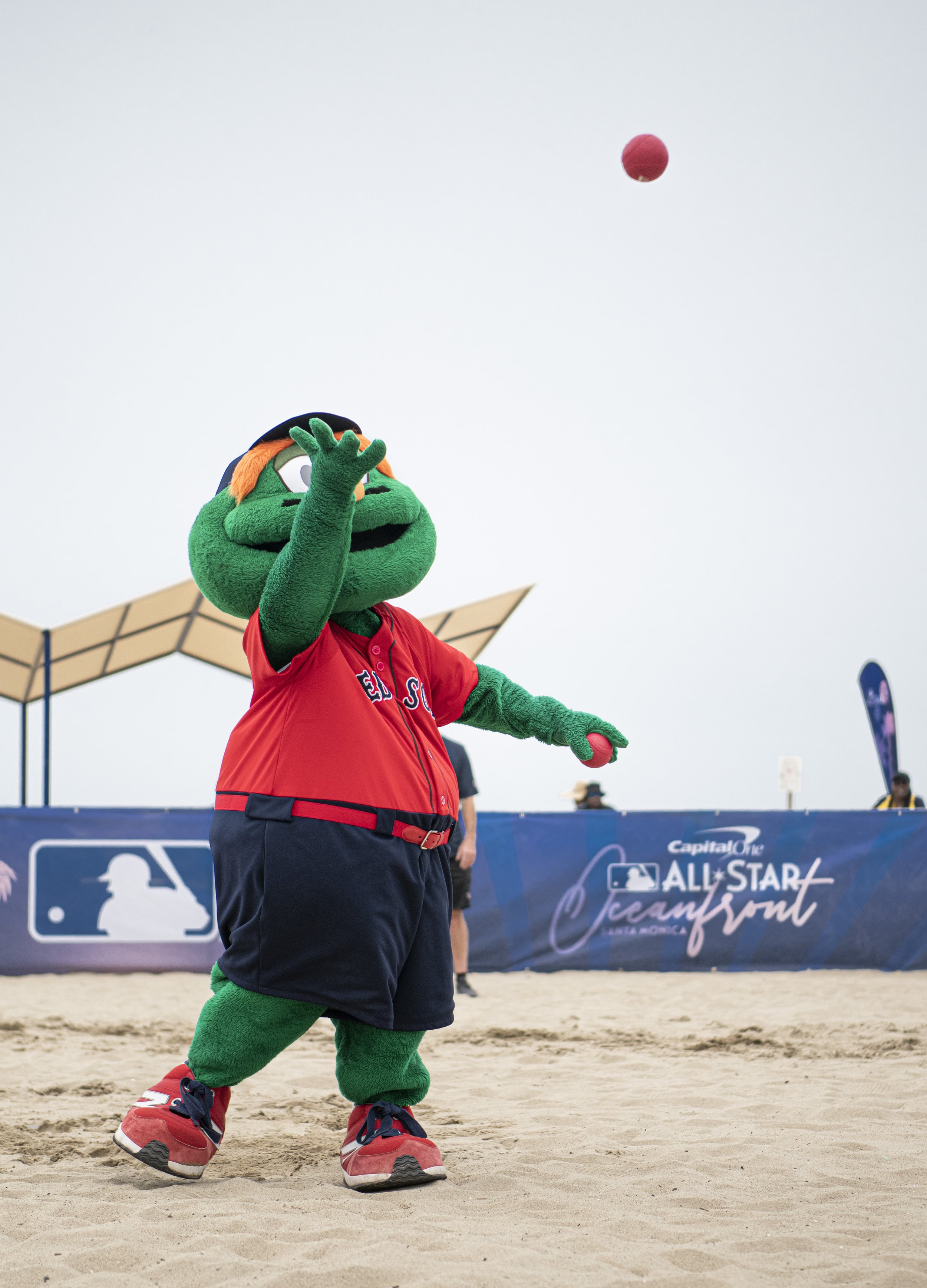  Wally the Green Monster tosses in a pitch to a eager fan at the fan vs. Mascott game. (Jon Putman | The Corsair) 