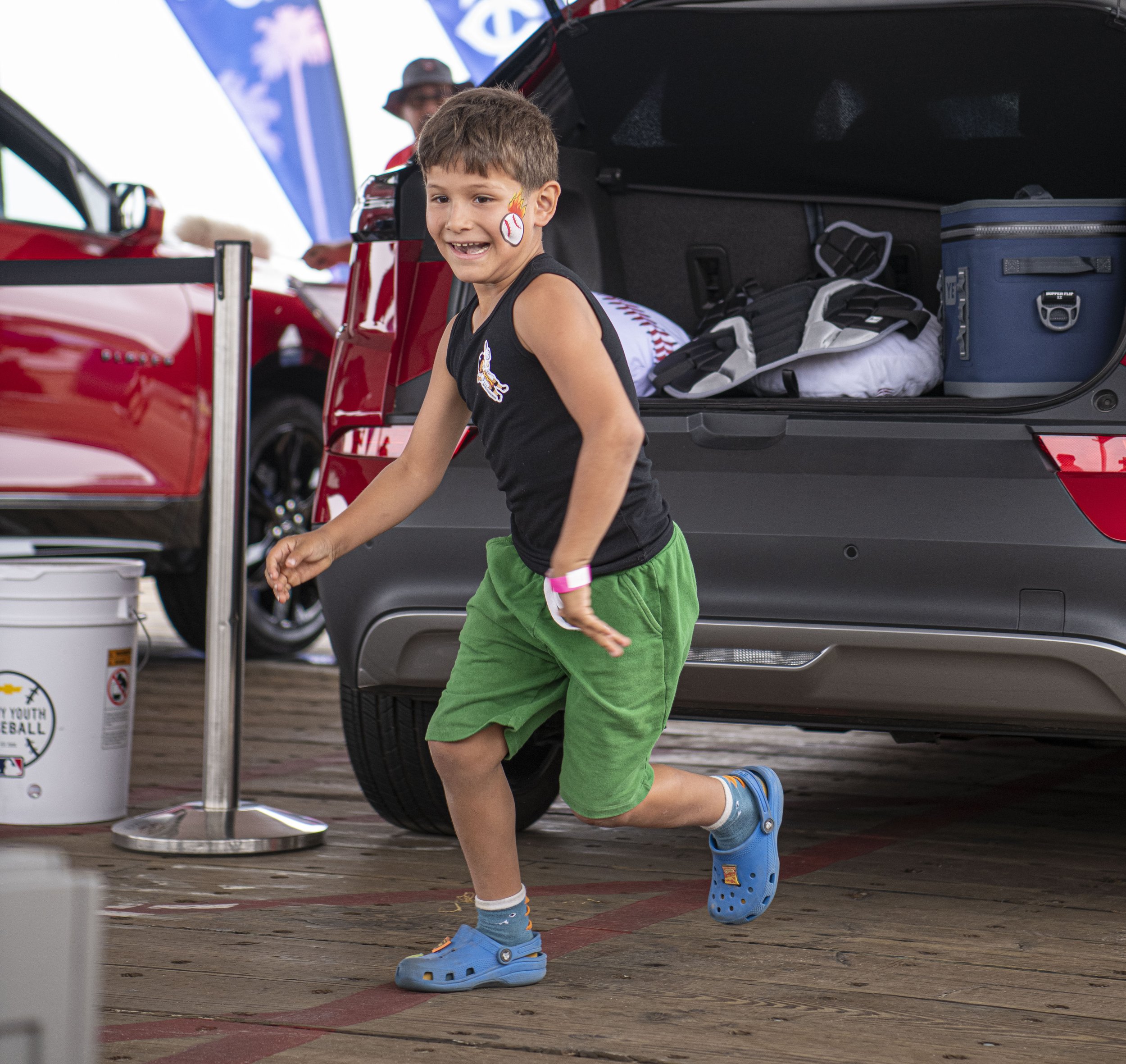  Alex (9) runs to retrieve another item to put into the vehicle during one of the events at the MLB All Star weekend festivities at the Santa Monica Pier. (Jon Putman | The Corsair) 
