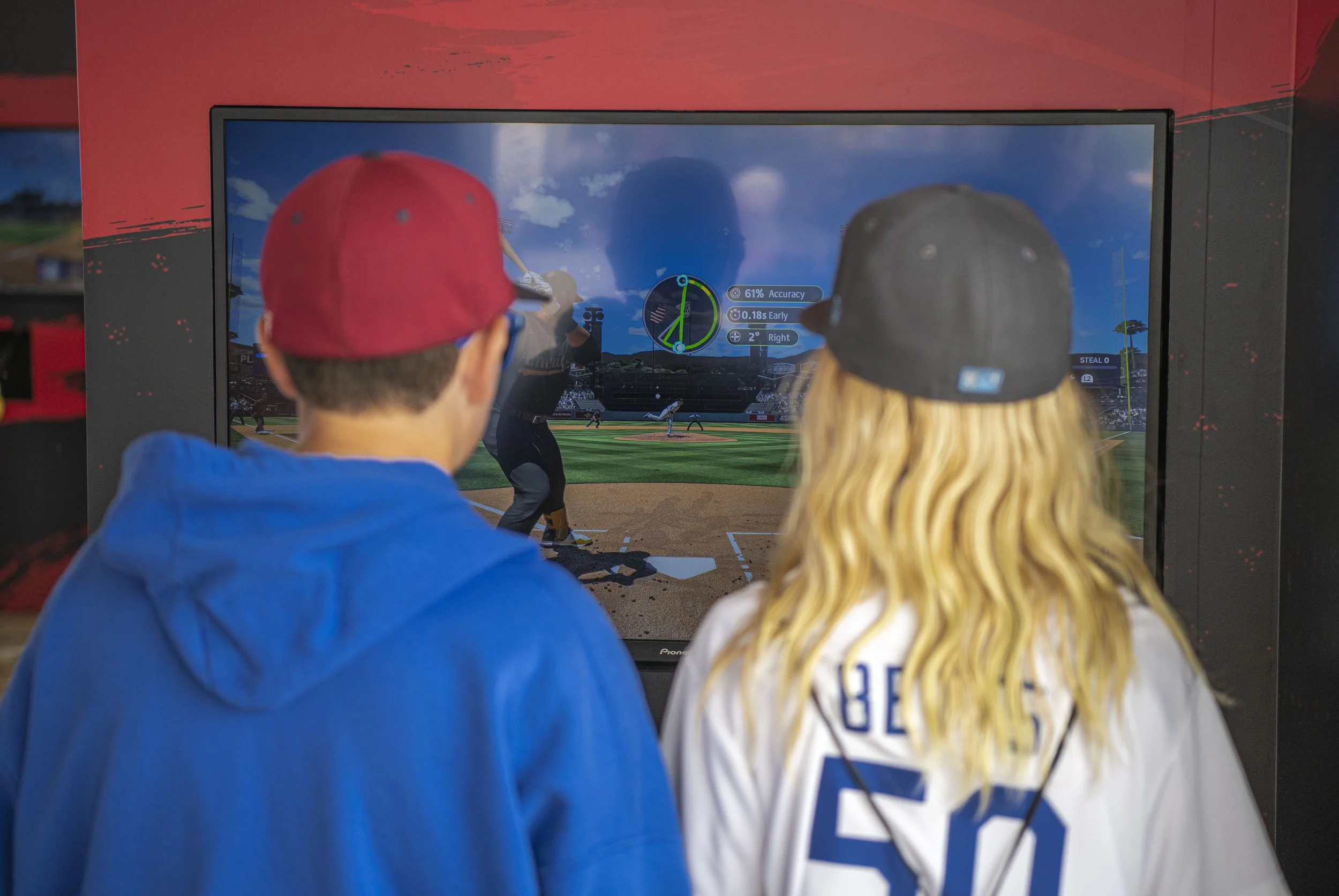 A couple young baseball fans battle it out in the new MLB 2k23 video game at the MLB All Star weekend festivities. (Jon Putman | The Corsair)