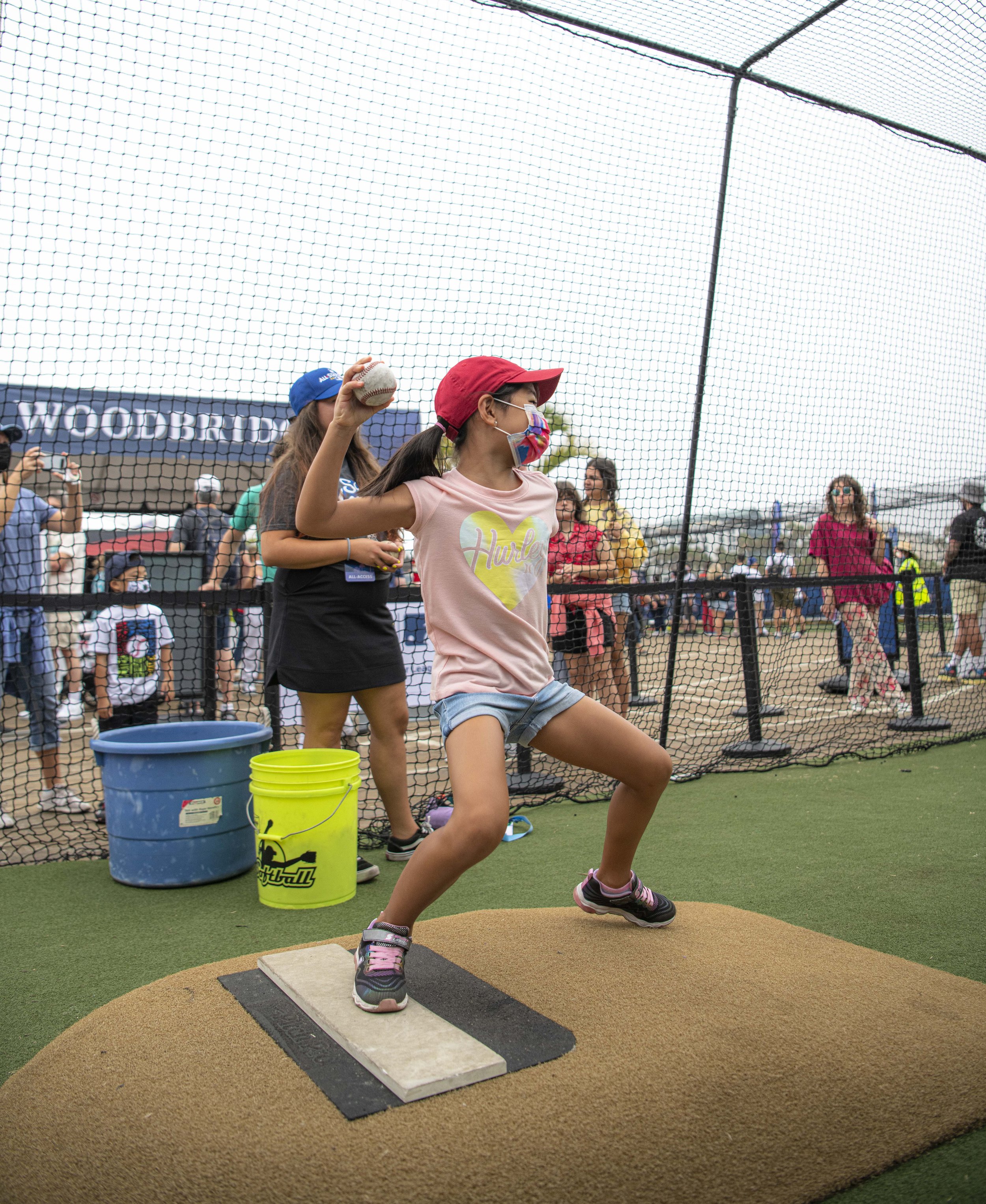  A young tourist from China gives it her all throwing a pitch at the Radar tent to check how fast participants could throw. (Jon Putman | The Corsair) 
