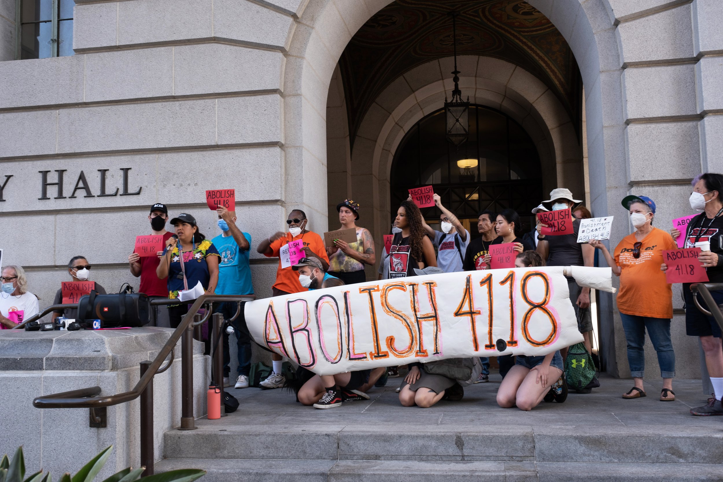  Los Angeles community members and activists gather outside of City Hall before the public hearing. Speeches are given by activists, who demand that municipal code 41.18 be abolished. Los Angeles City Hall. August 9, 2022. (Anna Sophia Moltke | The C