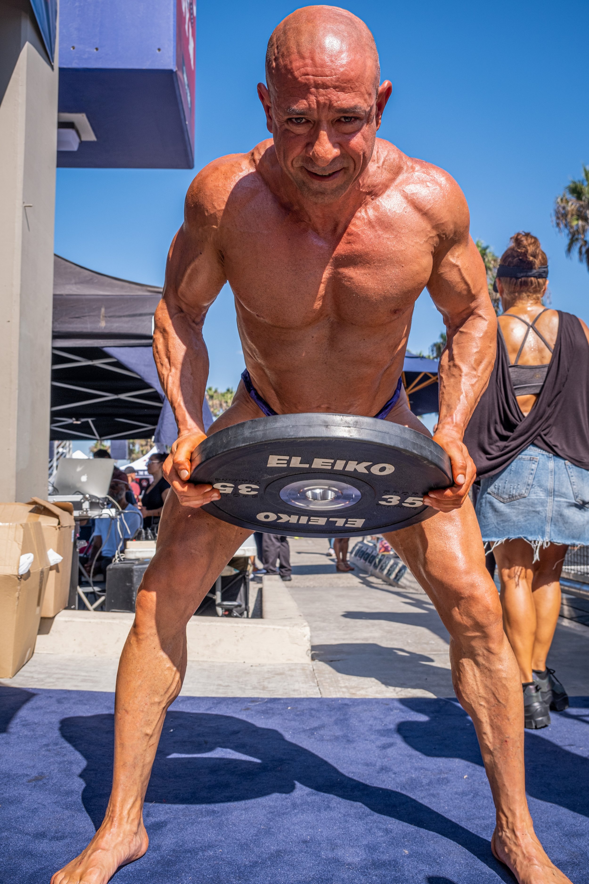  While preparing to head onto the stage, a bodybuilder lifts a 35-pound weight. His class is the Master’s Men Over 50 at The Muscle Beach Championship. Venice Beach Recreation Center, in Venice, Calif. on Labor Day, Monday, September 5, 2022. (Anna S