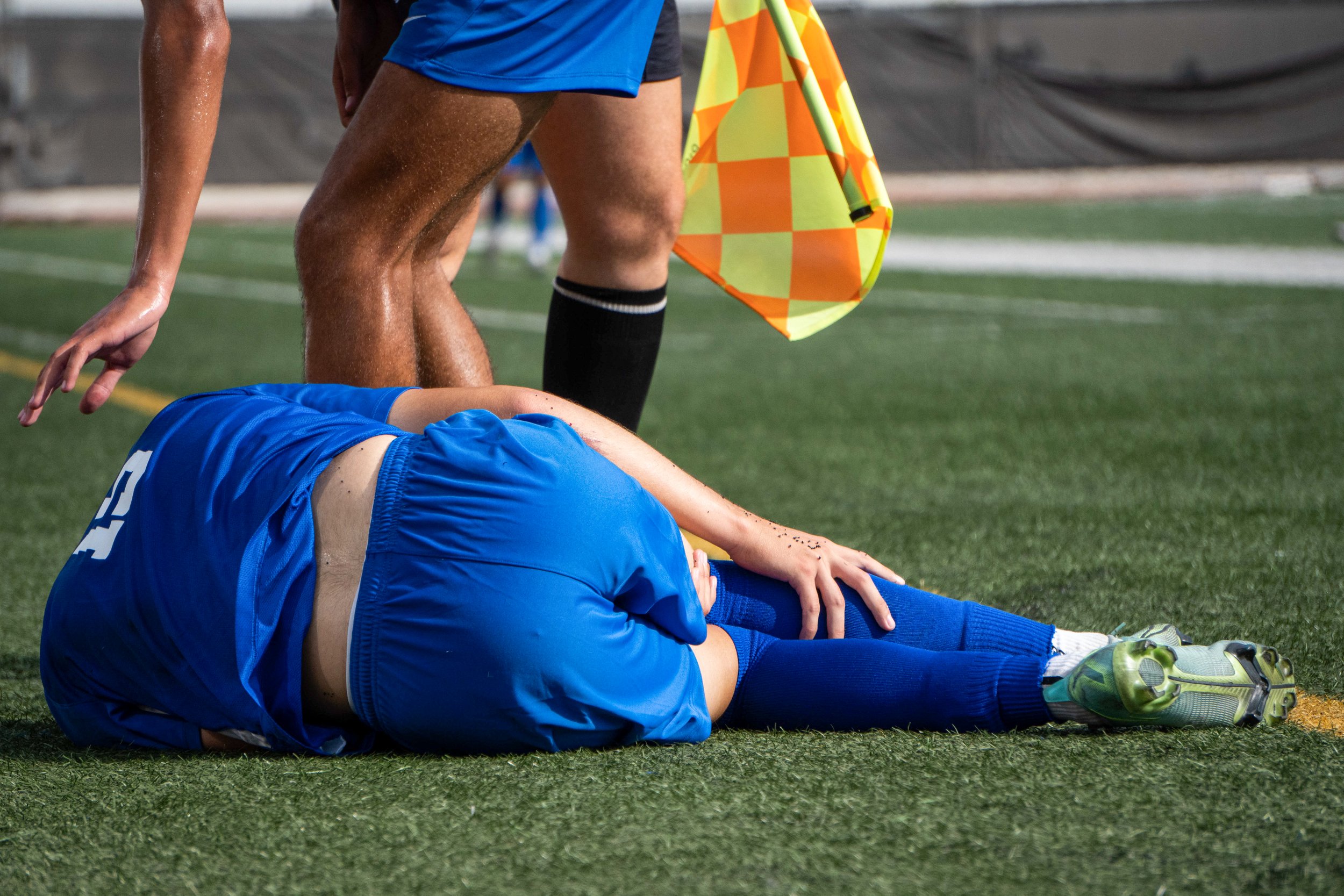  A referee and teammate check up on Santa Monica College Corsairs Alvin Rivas (15) as he clutches his leg in pain after tumbling to the ground from an on field collision. The Corsairs brought the game home, beating the Warriors 3 to 2. The Corsair Fi