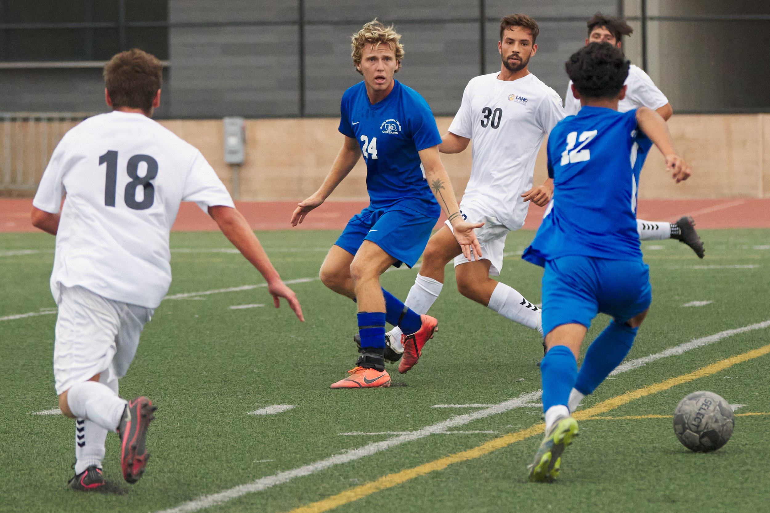  Alexander Lalor (center) and Jason Moreno (right), of the Santa Monica College Corsairs, and Isaias Hernandez (left) and [PLAYER 30], of the Los Angeles Harbor College Seahawks, during the men's soccer match on Friday, September, 9, 2022, at Corsair