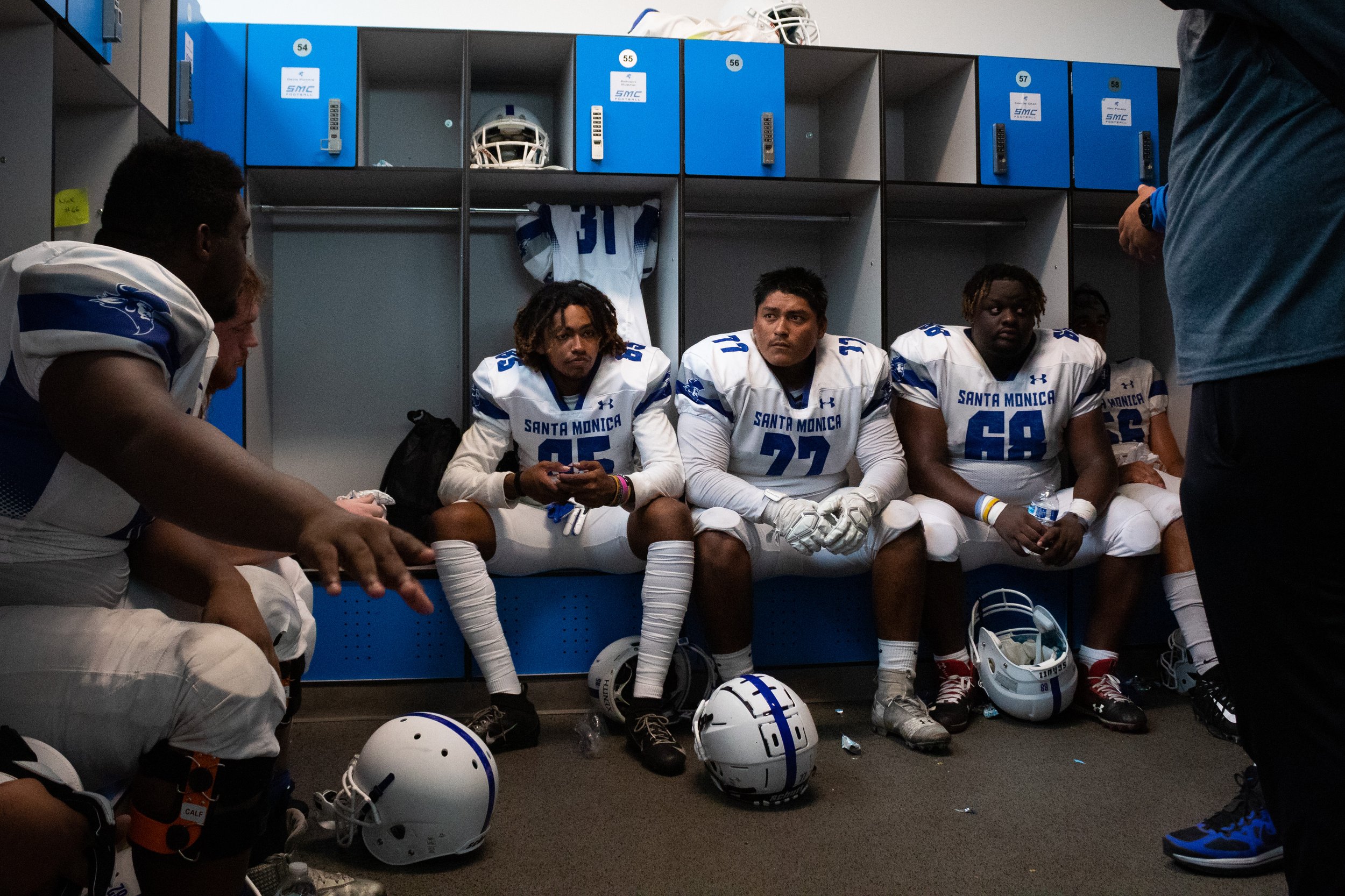  Devin Morris (left), Carlos Orea (middle), and Amir Brown (right) listening to their coaches among other members of the Corsair football team during halftime. The Lancers won with a final score of 27-20, on September 10, 2022, at Santa Monica Colleg