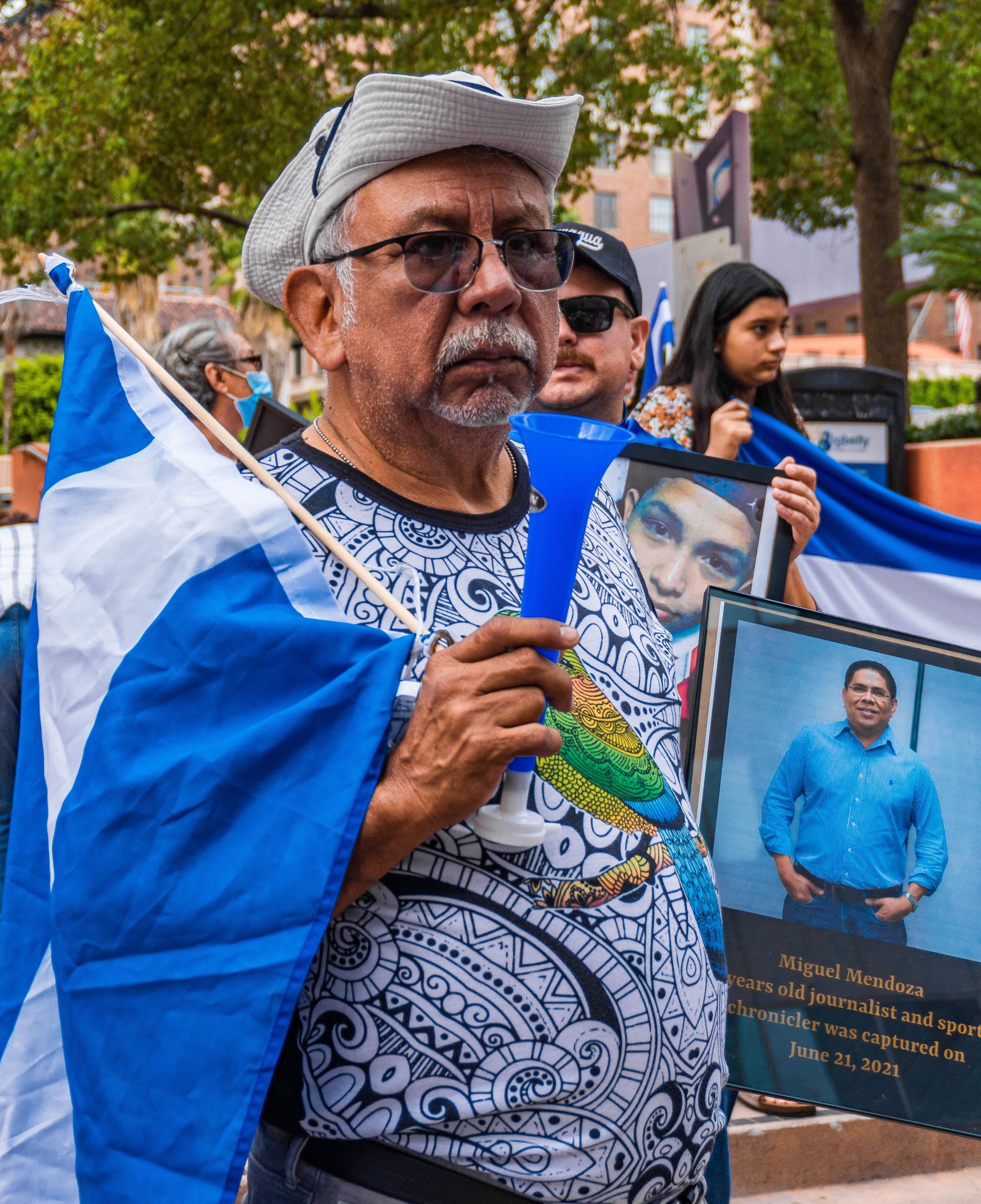  "I used to be a pro baseball player and he was a sports writer," says Alfonso Perez, as he holds a picture of journalist Miguel Mendoza. Mendoza has been captured by the Nicaraguan government since June 21, 2021. Downtown Los Angeles, CA. (Ee Lin Ts