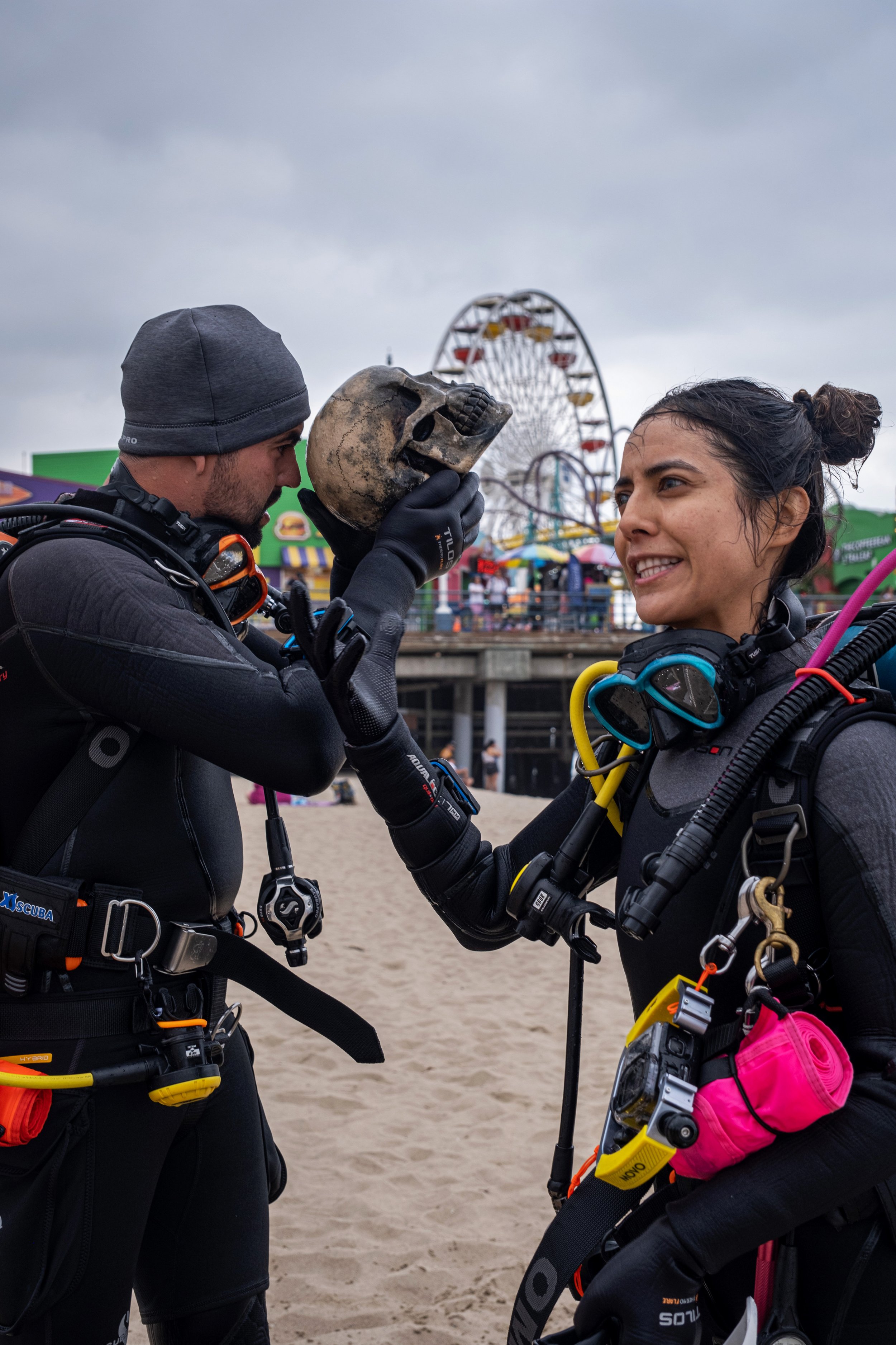  Alvin Alvarez (left) looks into the hole in the top of the skull that he collected while diving with Alma Alvarez (right) in the water surrounding the Santa Monica Pier for Coastal Cleanup Day, led by Heal The Bay in Santa Monica Calif. on Saturday,