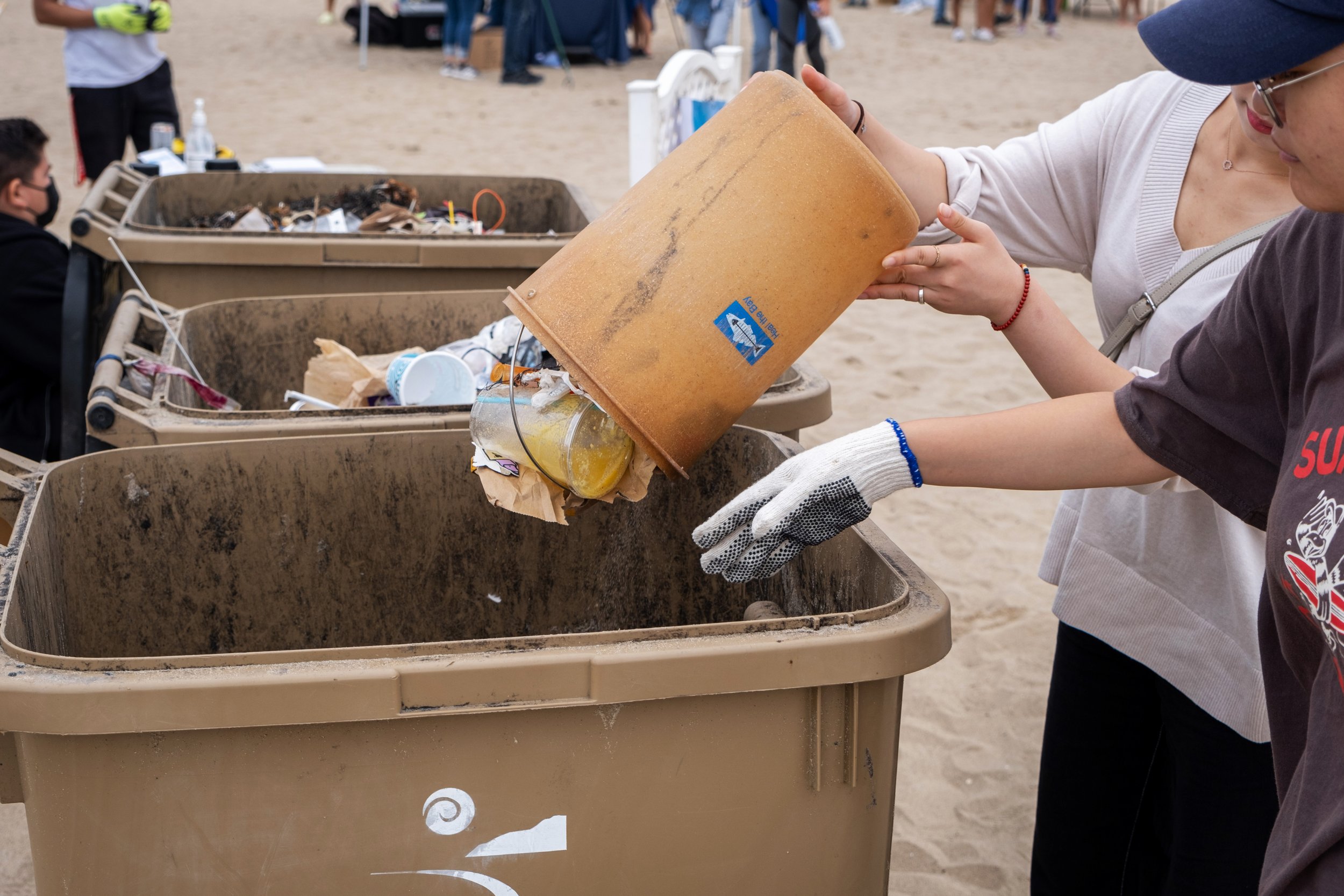  Christy Kim (left) and Eunoh Kim (right) empty a bucket full of garbage they collected along the beach, while participating at the Coastal Cleanup Day, led by Heal The Bay in Santa Monica Calif. on Saturday, September 17, 2022. Christy Kim and Eunoh