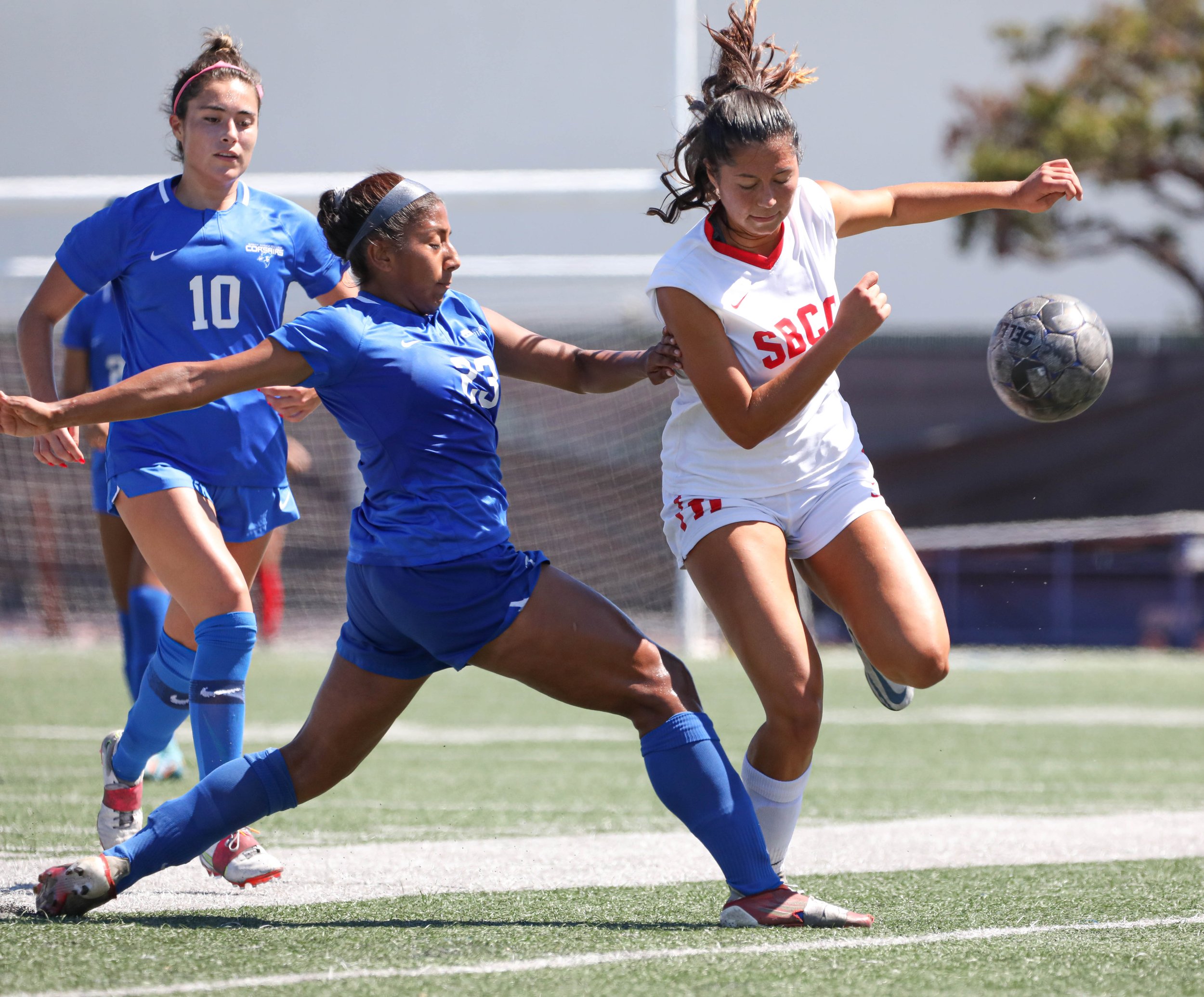  Santa Monica College(SMC) Corsairs midfielder Ali Alban (10,L) running to aid defender Carmen Talavera (23,M) who perfomed a standing tackle to get possesion of the ball from  defender Carmen Talavera (23,L) perfroming a standing tackle to get posse