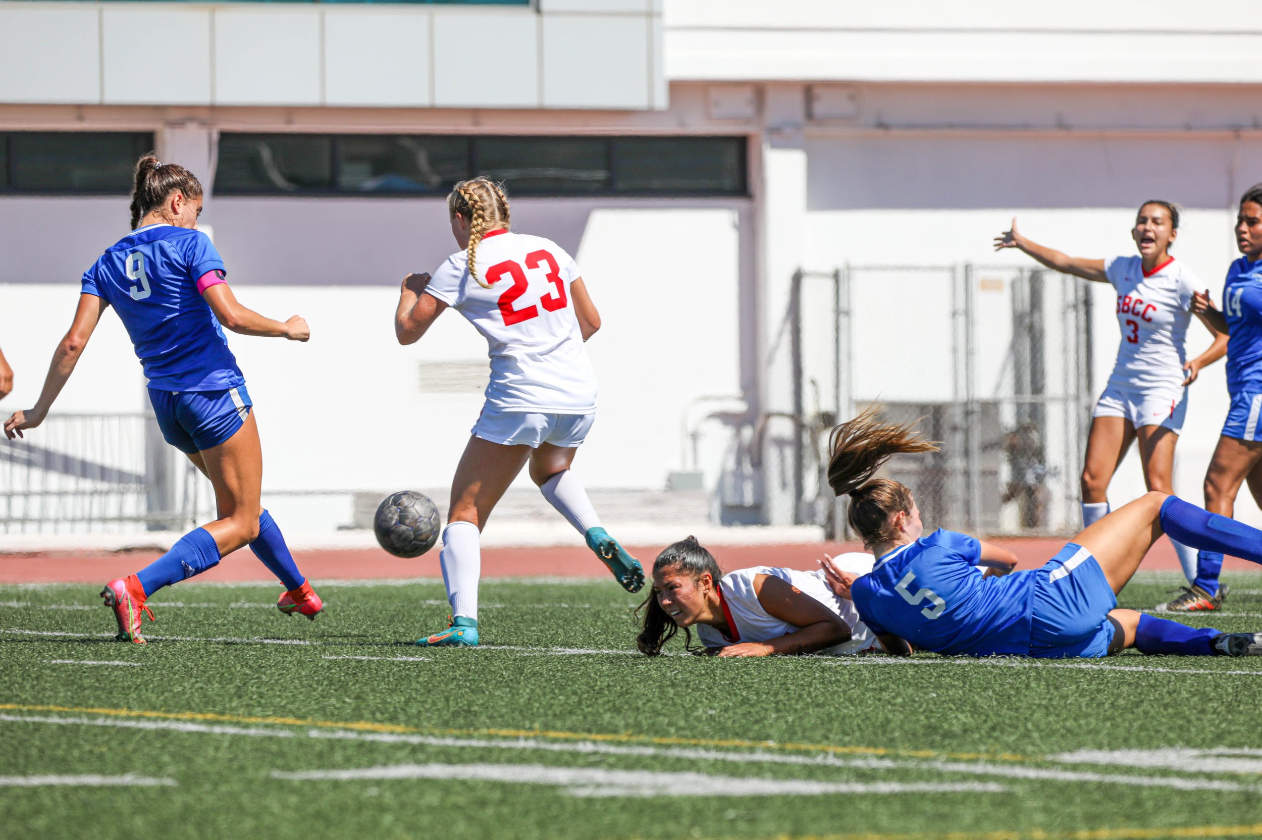  Santa Monica College(SMC) Corsairs defender and captain Alexia Mallahi (9) passing the ball to get it away from Santa Barbara City College(SBCC) Vaqueros forward Aly Springer (23). Corsairs defender Charlie Kayem (5,R) and Vaqueros forward Theresa E