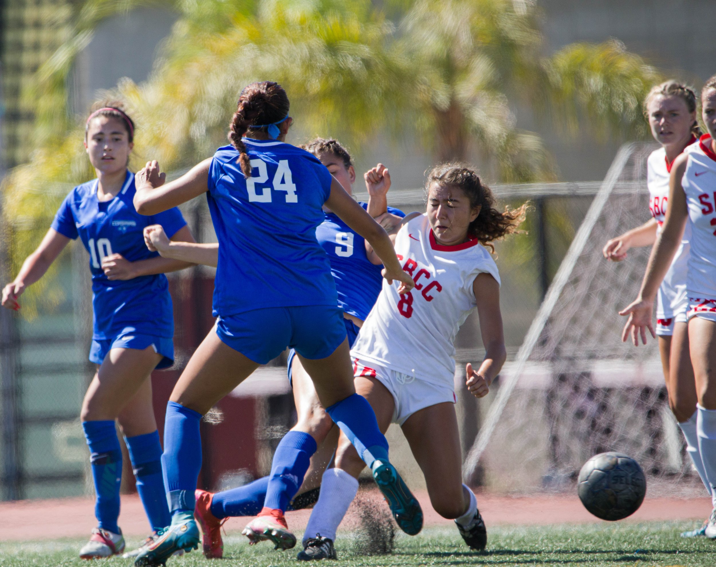  The Santa Monica College(SMC) Corsairs midfeilder Andrea Ortiz (24) and defender Alexia Mallahi stand tackling the ball away from Santa Barbara City College(SBCC) Vaqueros midfielder Gizela Zermeno on Tuesday, Sept. 20 at the Corsair Feild in Santa 