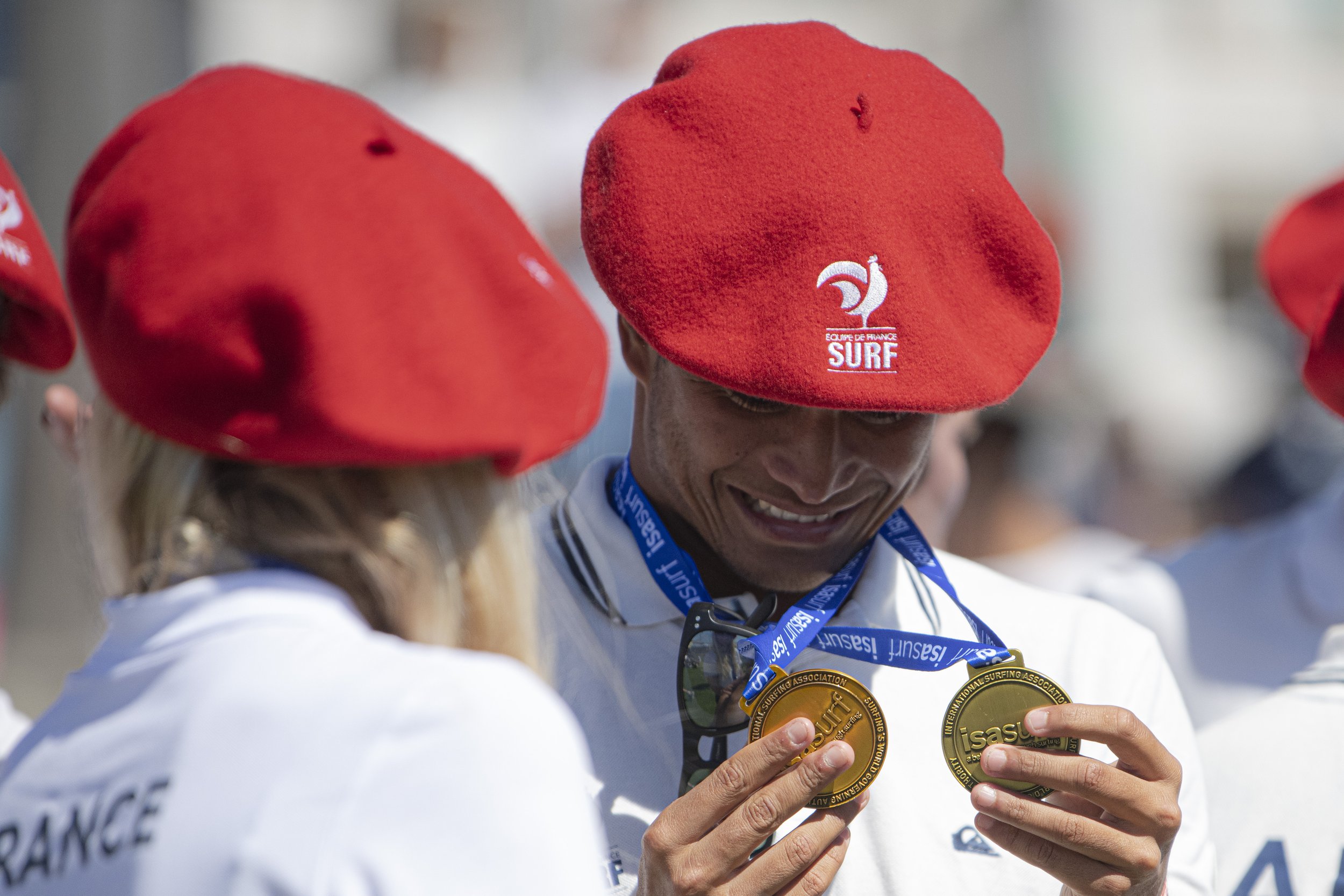  Members from team France look at the medals that they earned at the ISA World Surfing Games. (Jon Putman | The Corsair) 