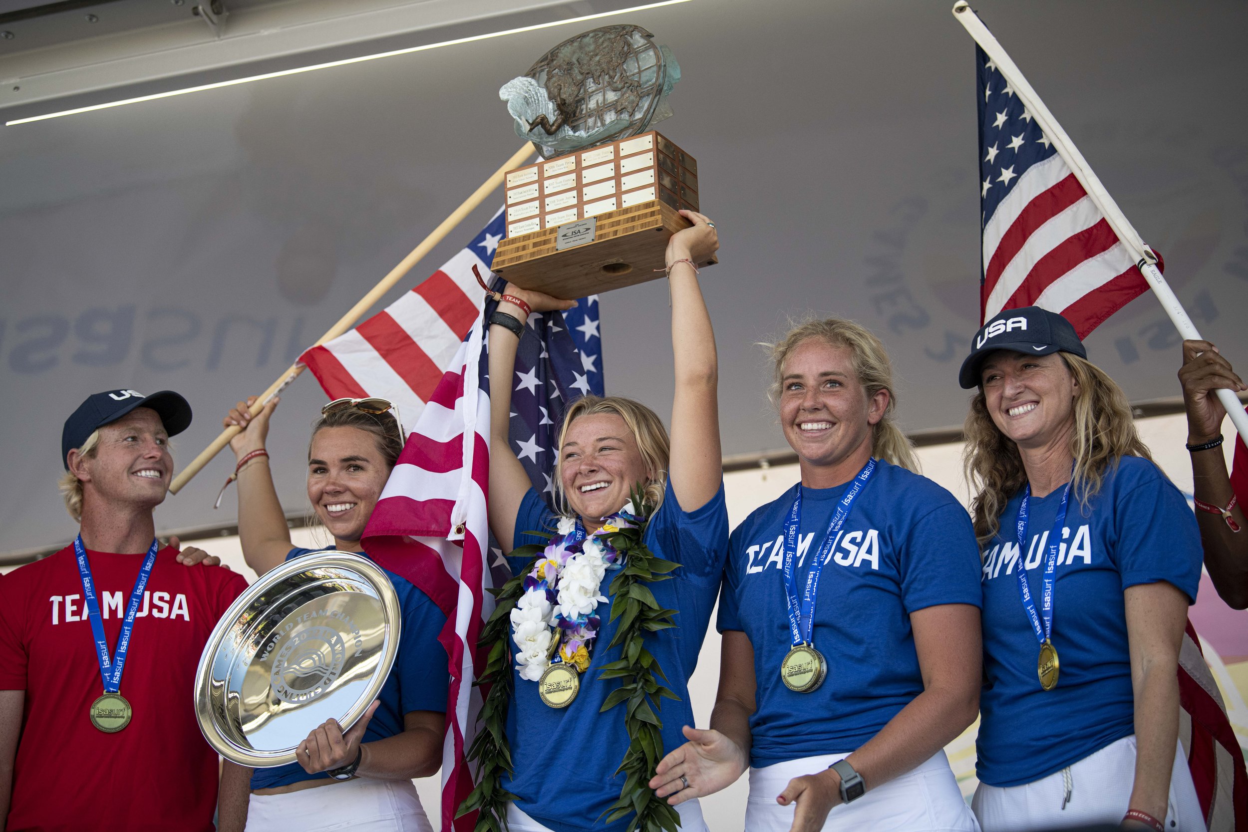  Team USA poses for the crowd as they embrace the gold medal earned and overall win at the ISA World Surfing Games. (Jon Putman | The Corsair) 