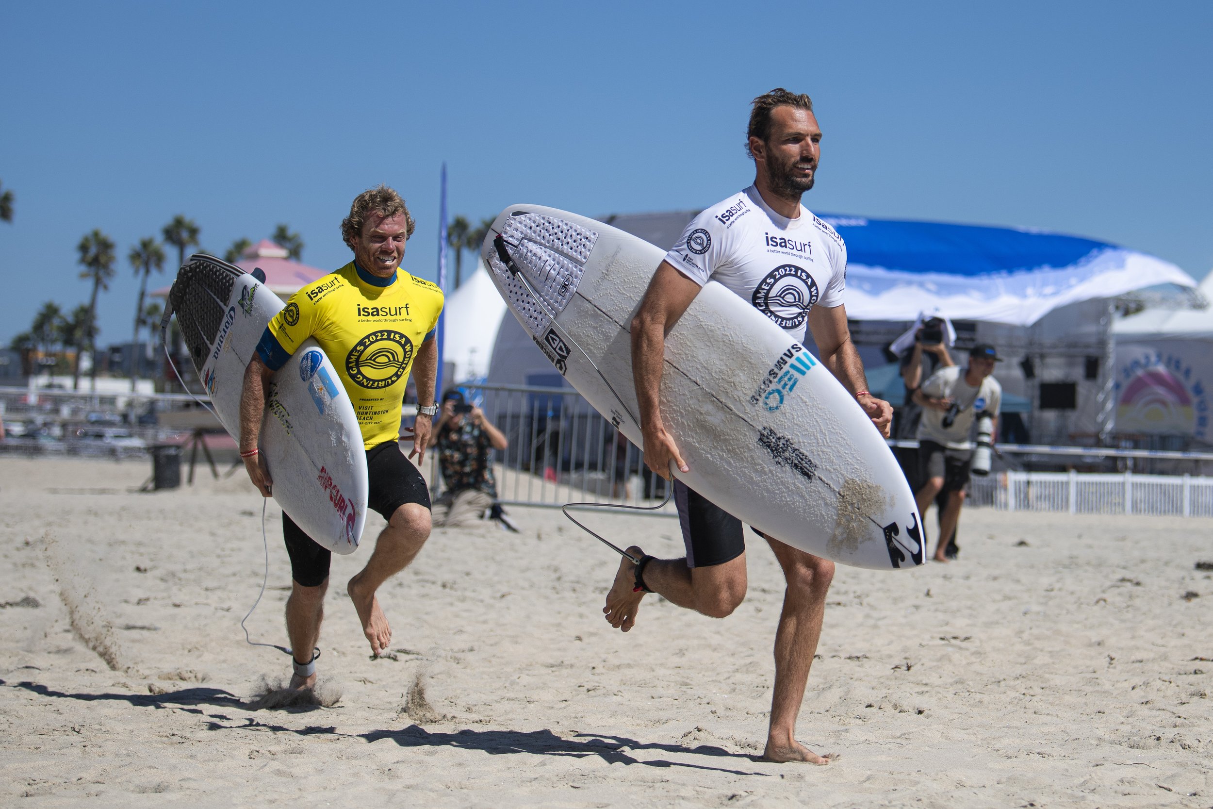  Darshan Antequera from Costa Rica (right) races against Dylan Groan (left) from Germany during the tandem competition at the ISA World Surfing Games. (Jon Putman | The Corsair) 