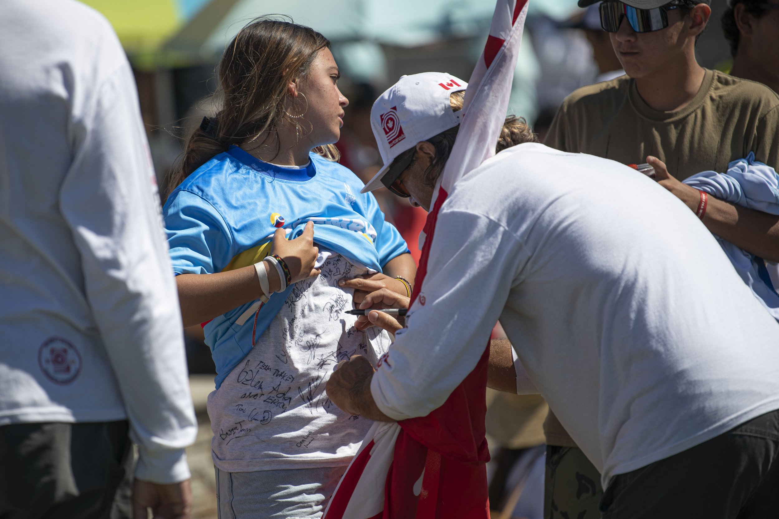  A fan gets her shirt signed by a member from team Canada at the award ceremony for the ISA World Surfing Games. (Jon Putman | The Corsair) 