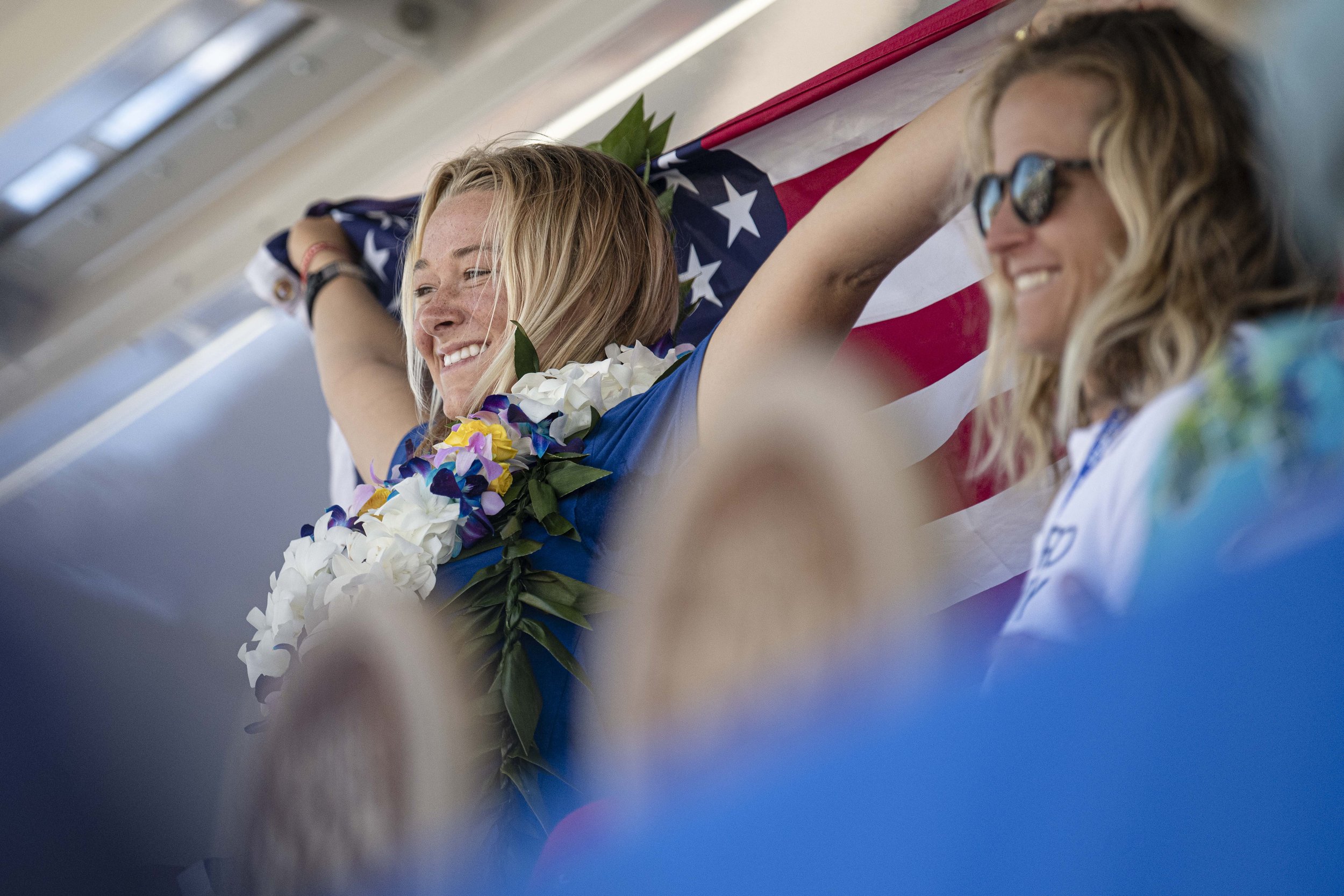  Kirra Pinkerton from team USA waves the American Flaf above her head after taking the gold medal at the 2022 ISA World Surfing Games. (Jon Putman | The Corsair) 
