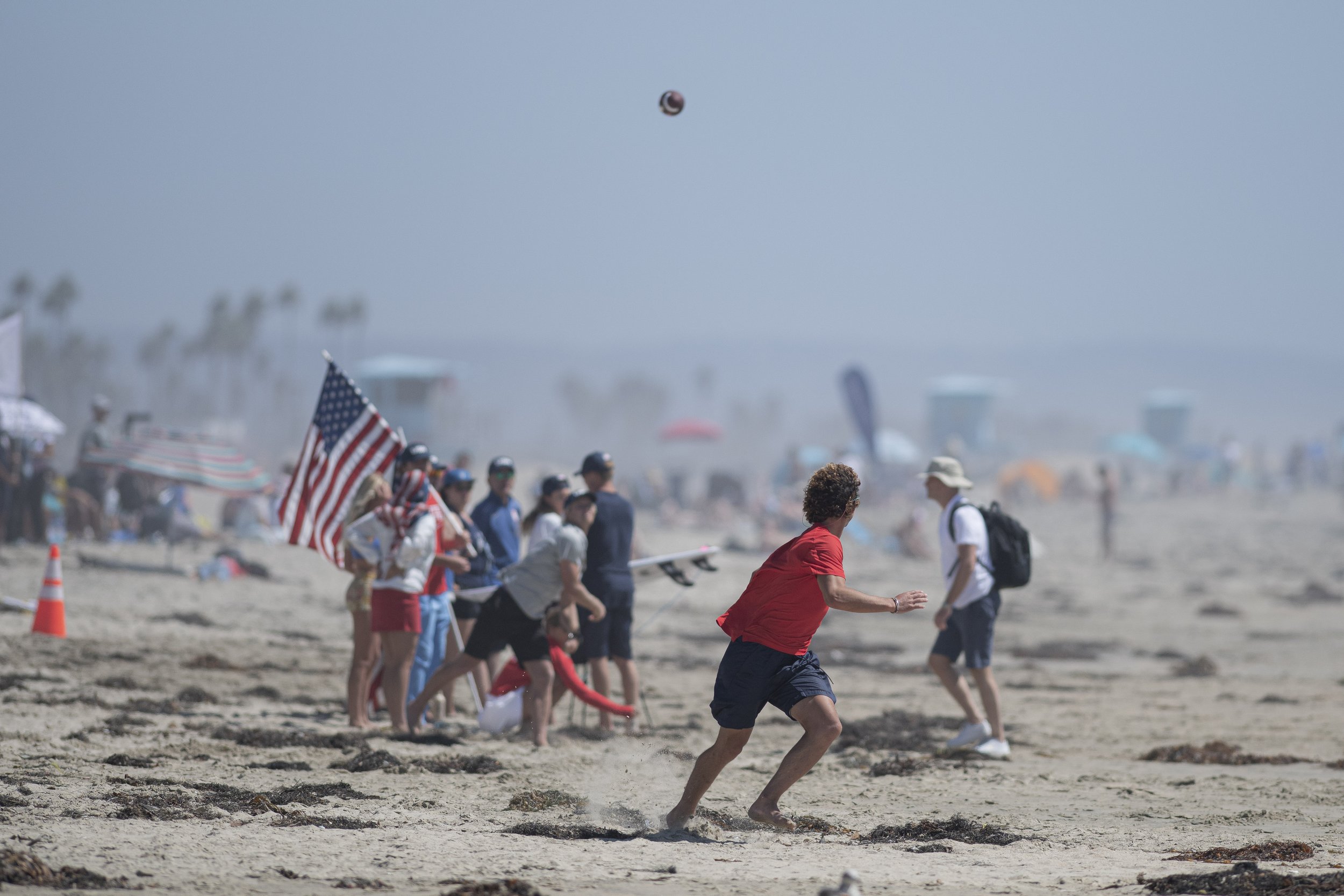  Members from team USA throw a football on the beach between their heats at the ISA World Surfing Games. (Jon Putman | The Corsair) 