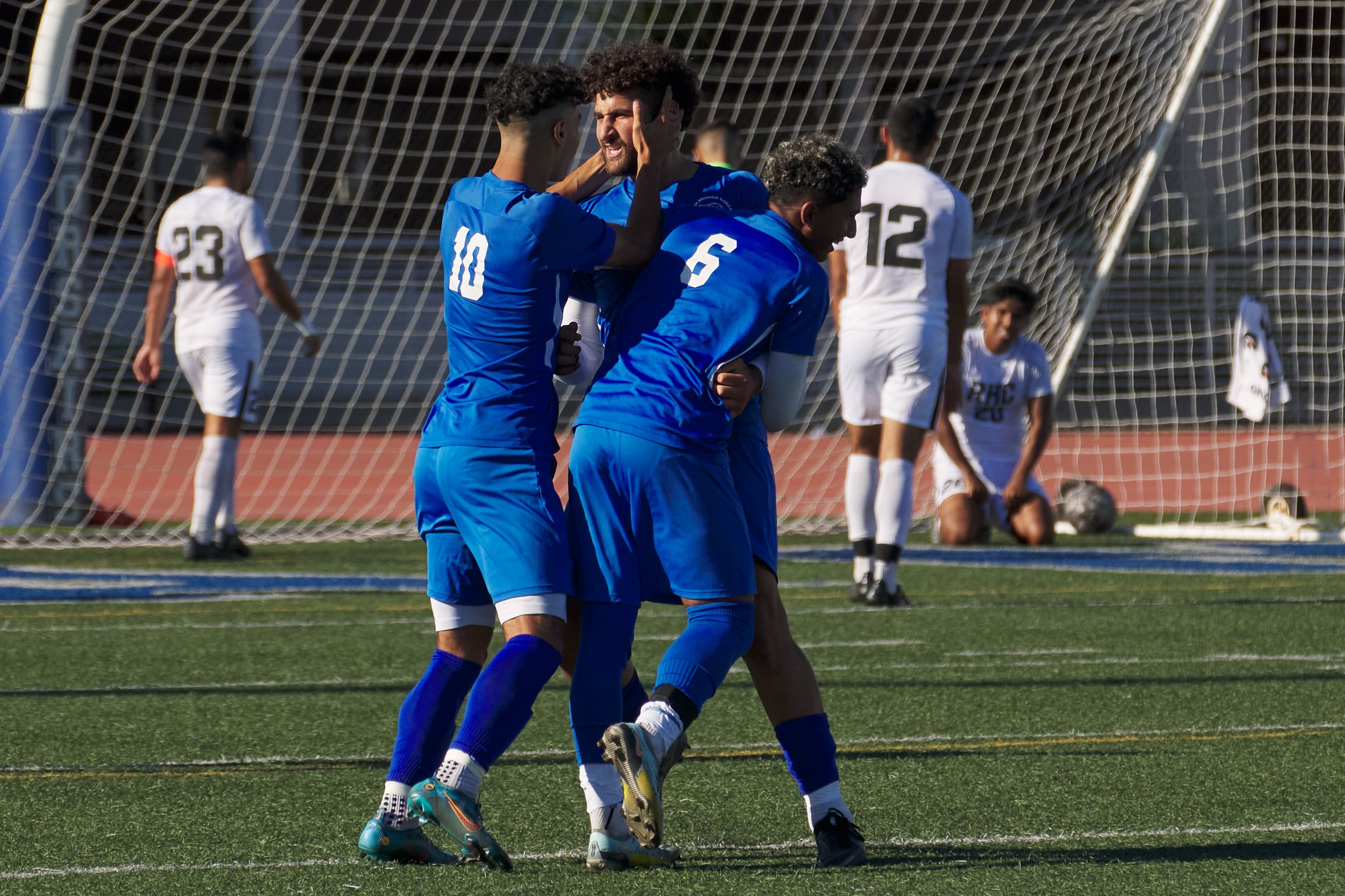  Santa Monica College Corsairs Men's Soccer teammates Roey Kivey (10) and Sebastian Alvarez Luna (6) celebrate with Adam Abou-Hamad (center) after he scored the winning goal for the Corsairs during the match against the Rio Hondo College Roadrunners 