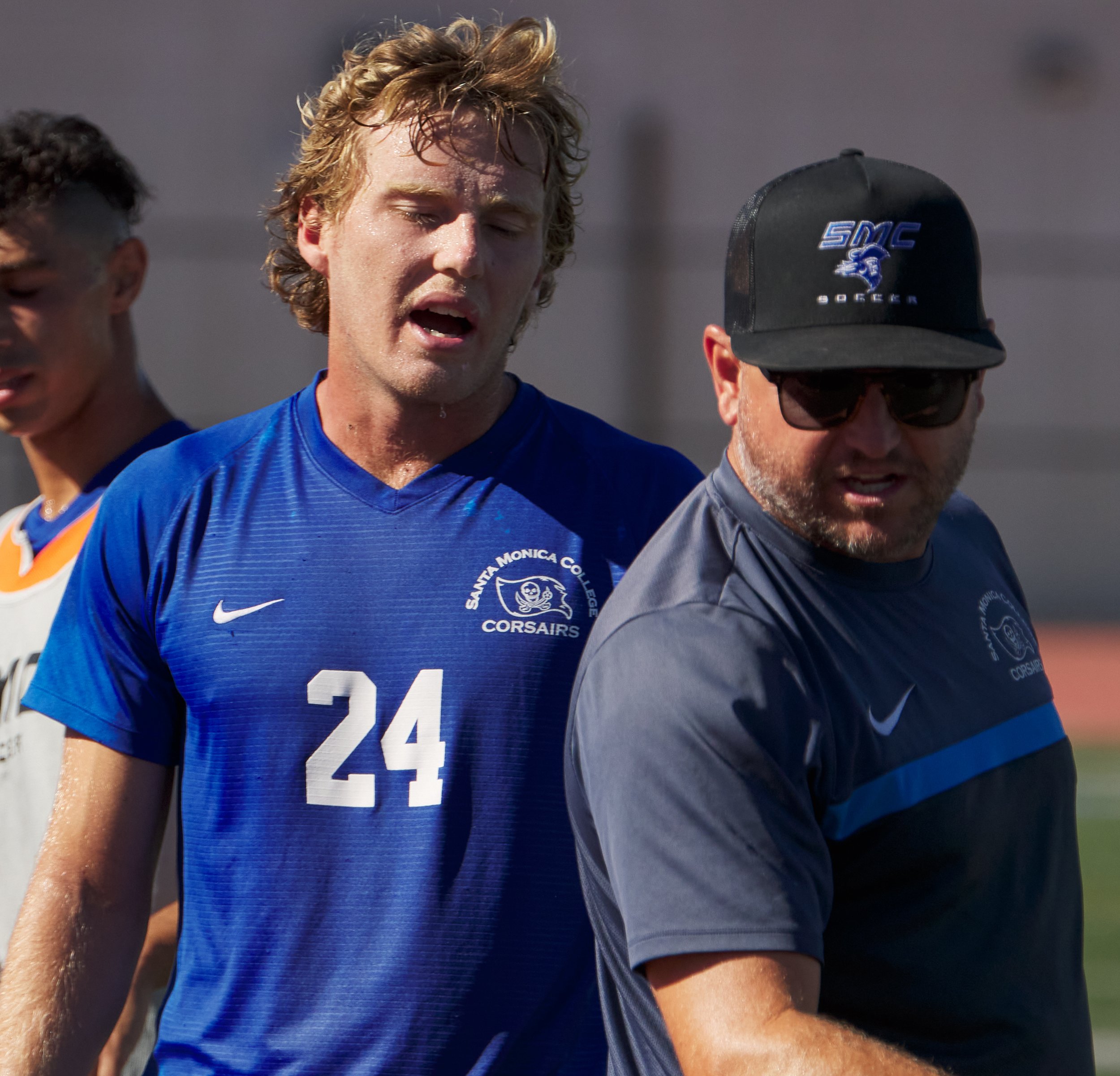  Santa Monica College Corsairs Men's Soccer Head Coach Tim Pierce (right) talks with Alexander Lalor (left), who just scored the first goal of the match against the Rio Hondo College Roadrunners on Friday, Sept. 24, 2022, at Corsair Field in Santa Mo
