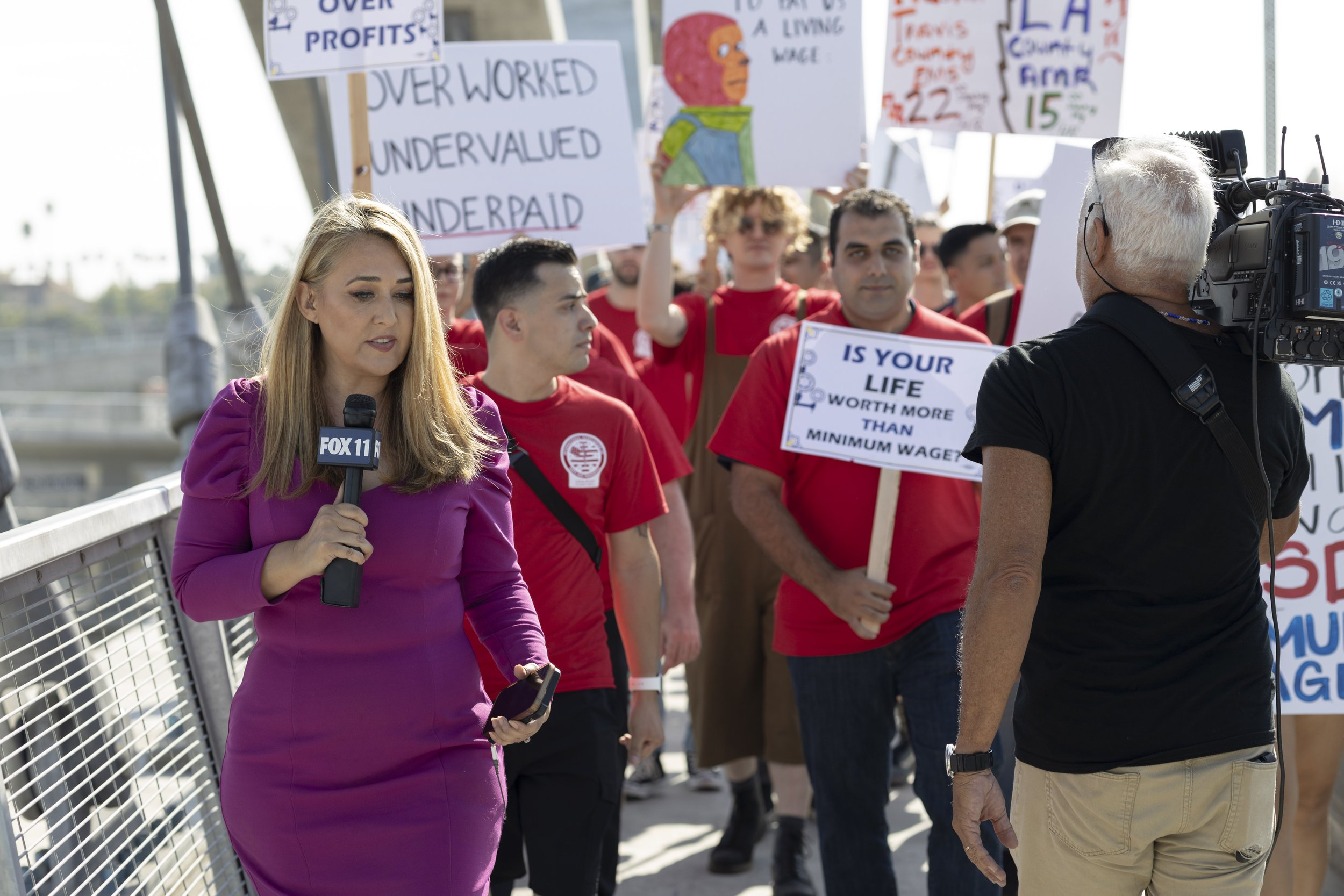  Christie Fajardo (left) from Fox 11 News walked with the group of EMS workers marching for fair wages on September 13, 2022 in downtown Los Angeles, Calif. (Jamie Addison|The Corsair) 