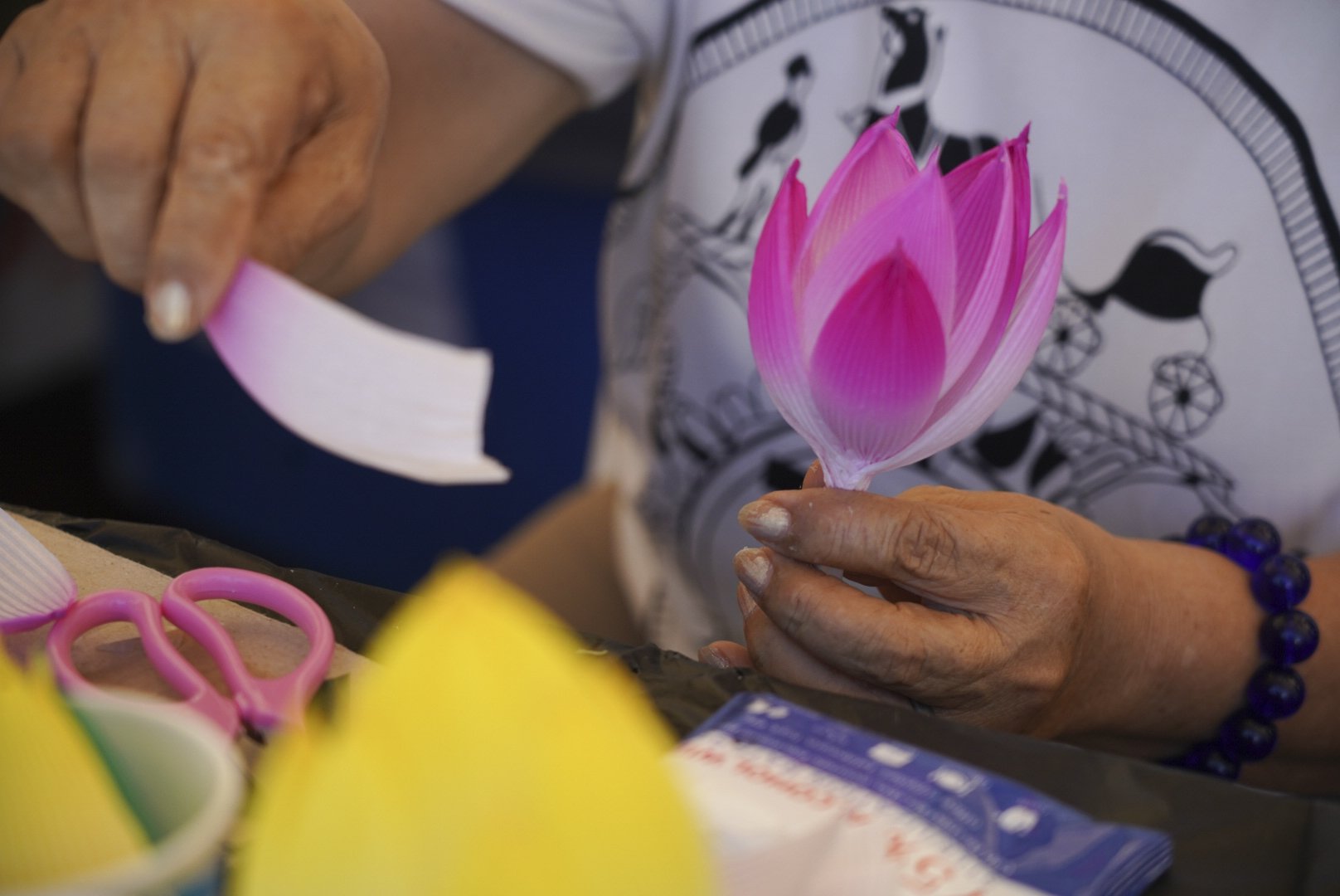  A paper lotus flower is assembled during the 49th annual Los Angeles Korean Festival Friday, September 23 2022 at the Seoul International Park. Papercraft is a traditional Korean art often used to construct intricite lanterns.  (The Corsair | Anthon