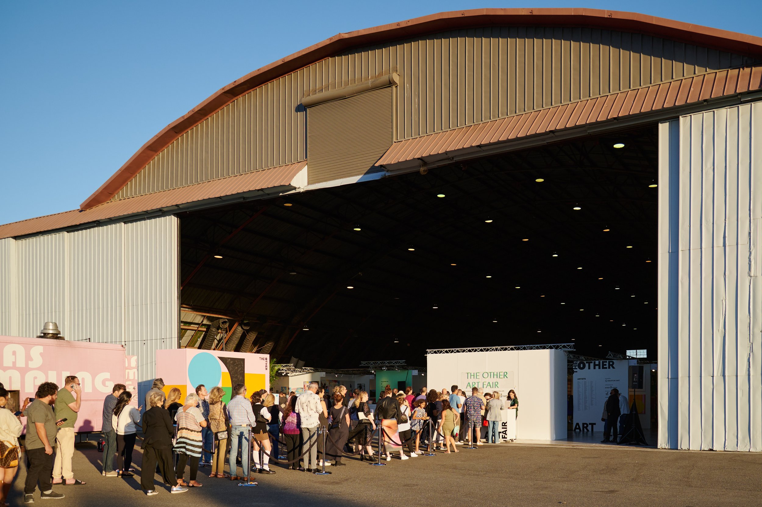  The entrance to The Other Art Fair with people lined up to get in on Thrusday, Sept. 22, 2022, at The Barker Hangar in Santa Monica, Calif. (Nicholas McCall | The Corsair) 