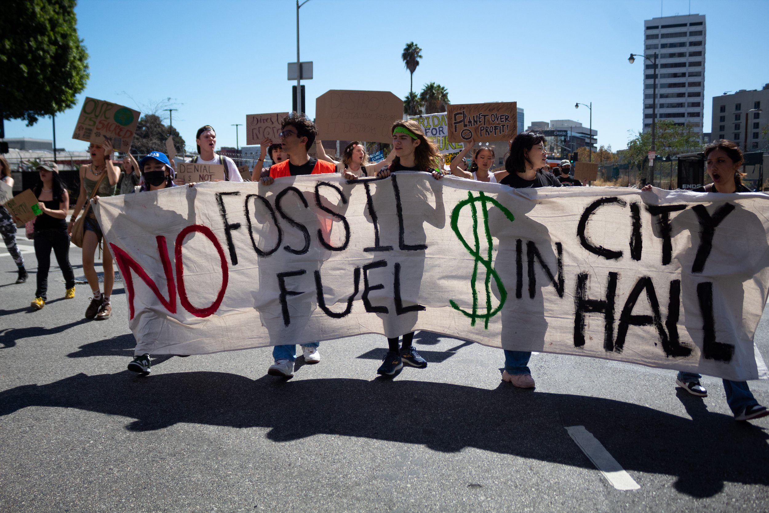  Strikers holding a sign that reads "no fossil fuel [money] in city hall" on Los Angeles Street after marching from Los Angeles City Hall during the Youth Climate Strike in Los Angeles, Calif. on Sept. 23, 2022. 