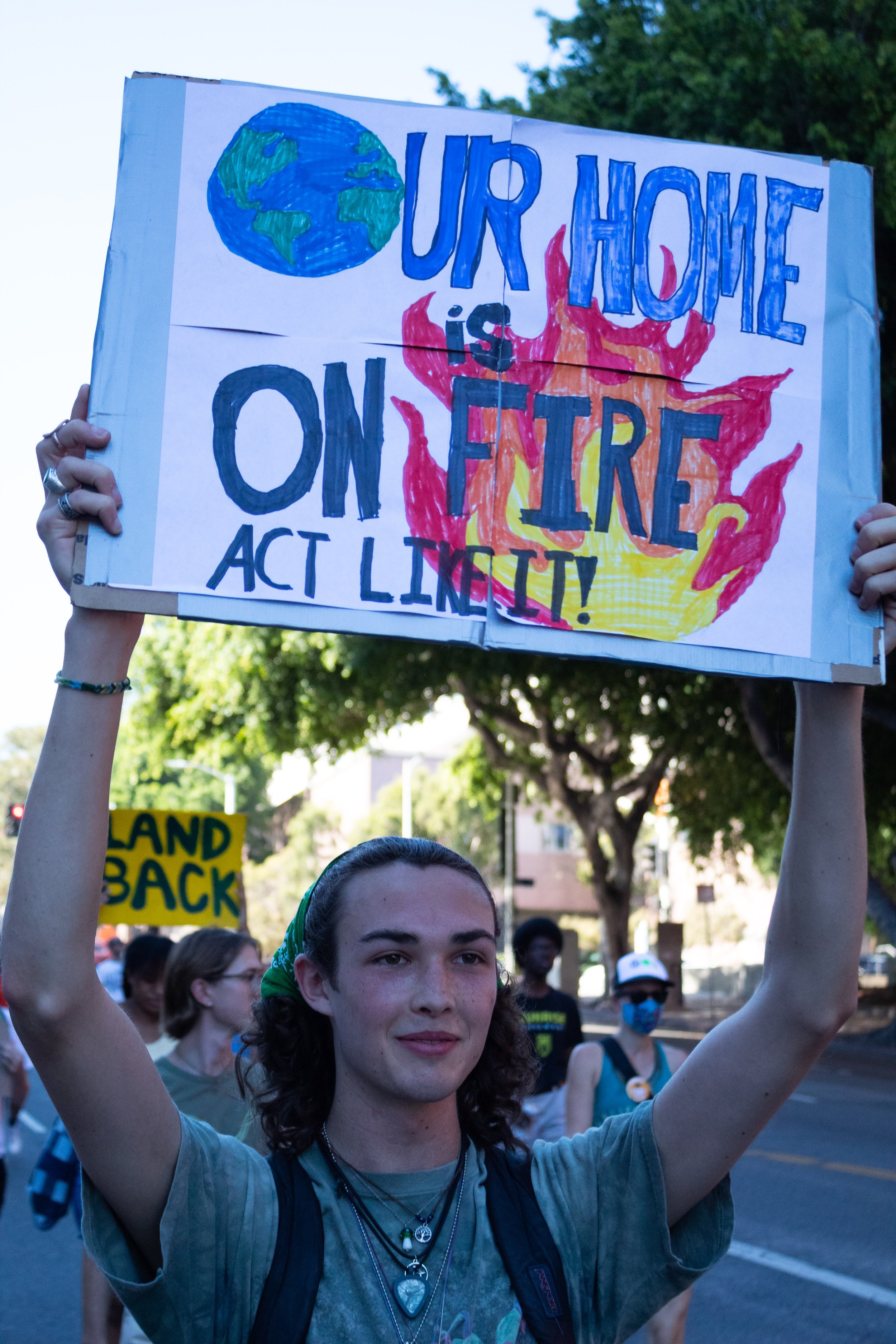  Miles Griffin, 17, holding up a sign that says, "our home is on fire act like it" and striking down 1st Street during the Youth Climate Strike in Los Angeles, Calif. on Sept. 23, 2022. (Caylo Seals | The Corsair) 