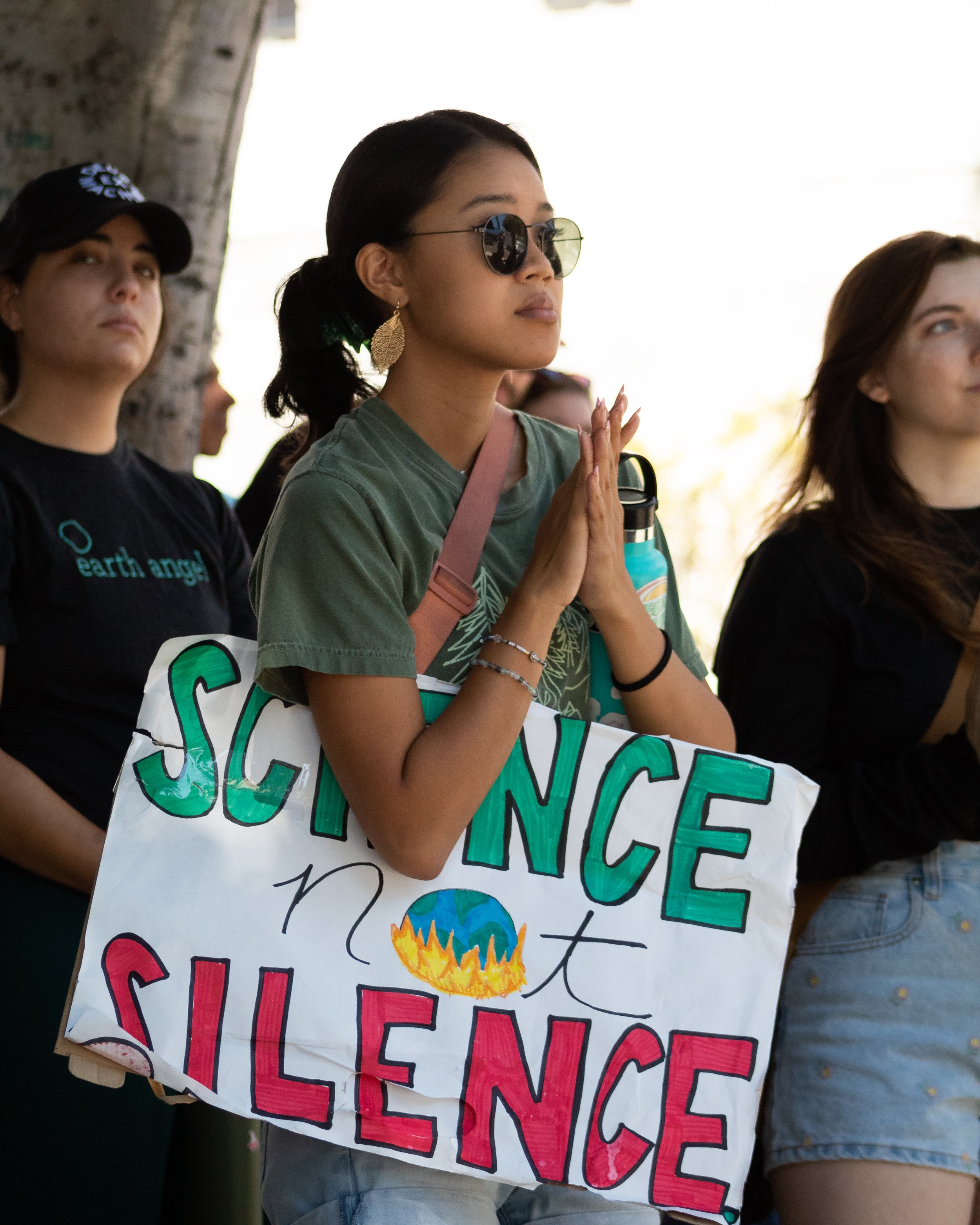  Laurel Tamayo, 23, watching speakers read off a list of climate change demands during the Youth Climate Strike at the Los Angeles City Hall, Los Angeles, Calif. on Sept. 23, 2022. (Caylo Seals | The Corsair) 