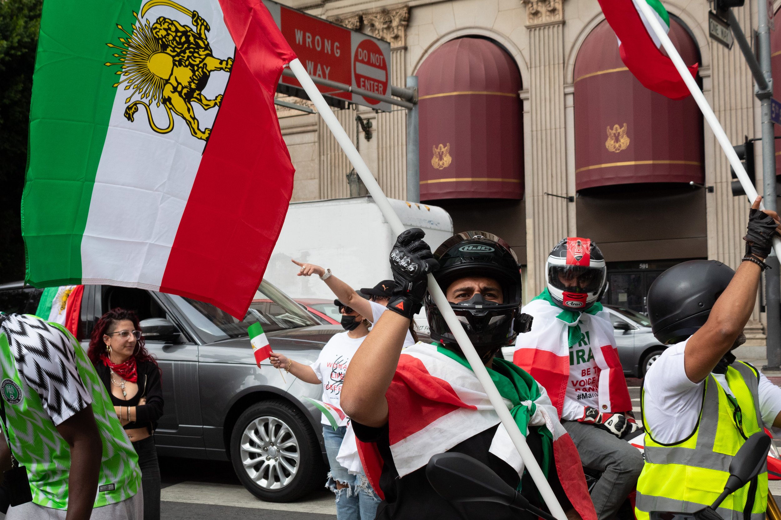  Parsha Abadi holding up the Iranian flag while sitting on his motorcycle waiting for the Freedom For Iran rally to begin its march from Pershing Square to Los Angeles City Hall. The rally marched from Pershing Square to Los Angeles City Hall with at