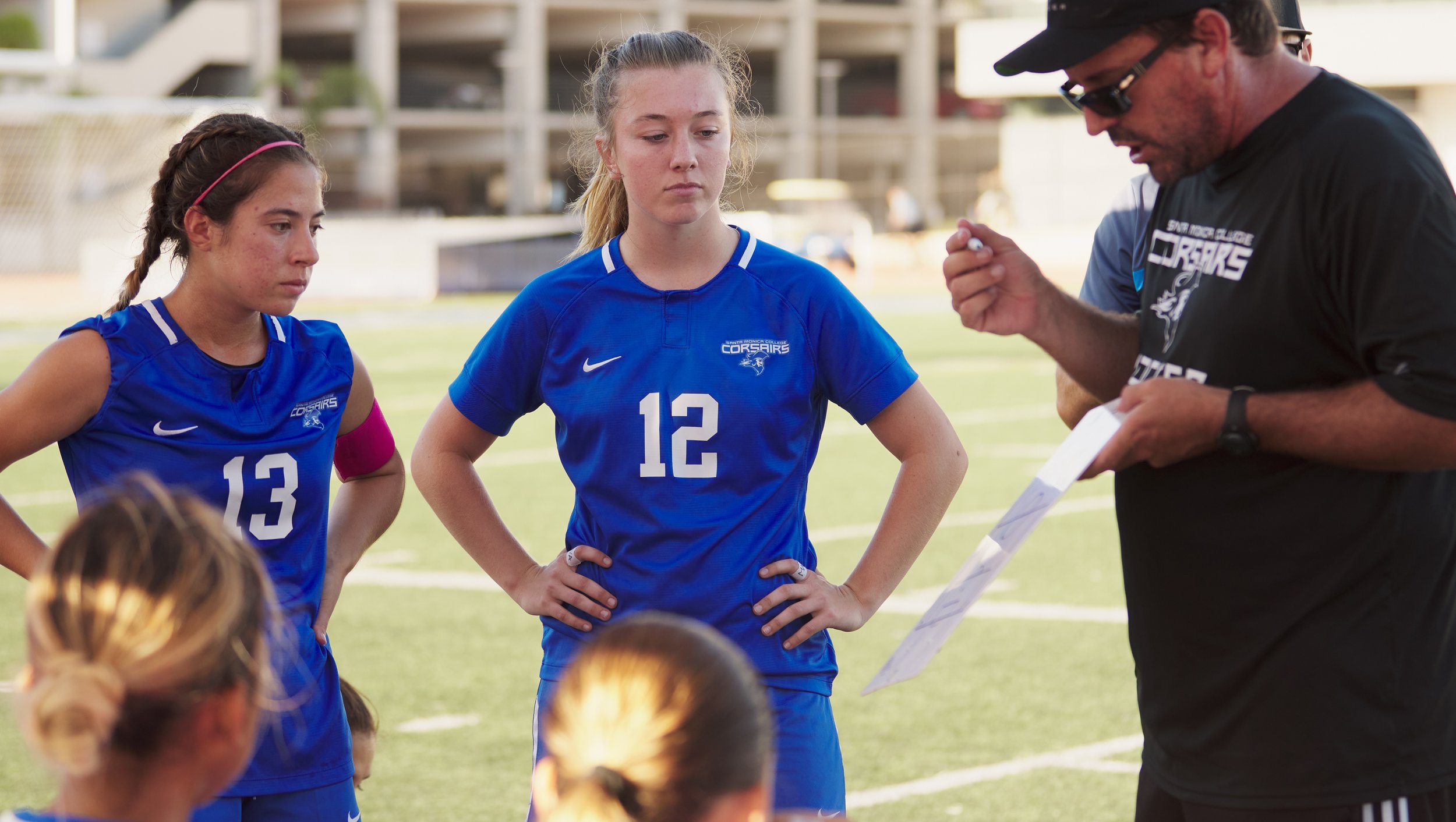  Santa Monica College Corsairs' Sophie Doumitt and Eden Hotch listen to Head Coach Aaron Benditson during the women's soccer match against the West Los Angeles College Wildcats on Friday, Sept. 30, 2022, at Corsair Field in Santa Monica, Calif. The C