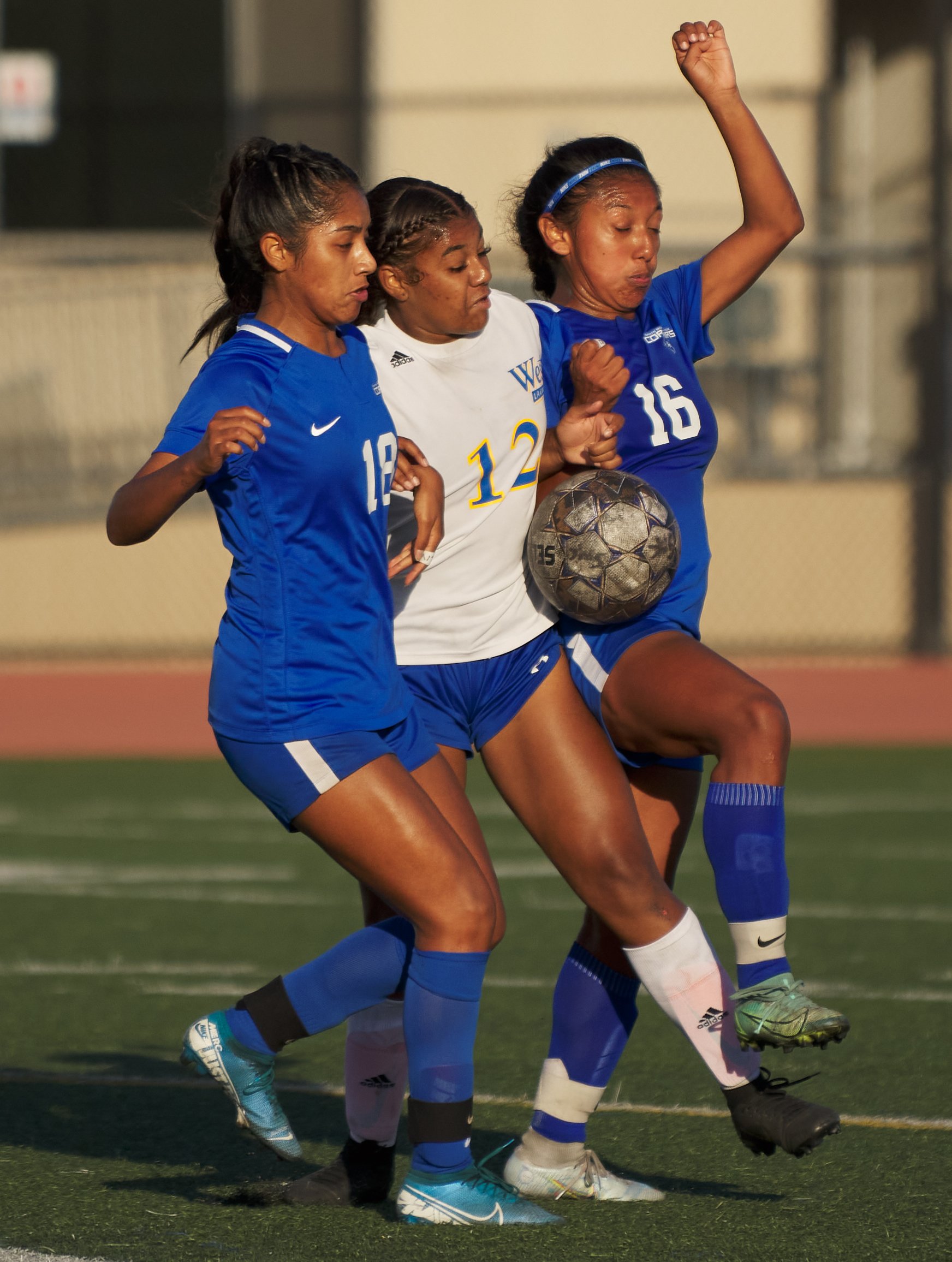  Santa Monica College Corsairs' Kaitlyn Romero (left) and Diana Gaspar (right), and West Los Angeles College Wildcats' Amarah Martinez struggle for control of the ball during the women's soccer match on Friday, Sept. 30, 2022, at Corsair Field in San