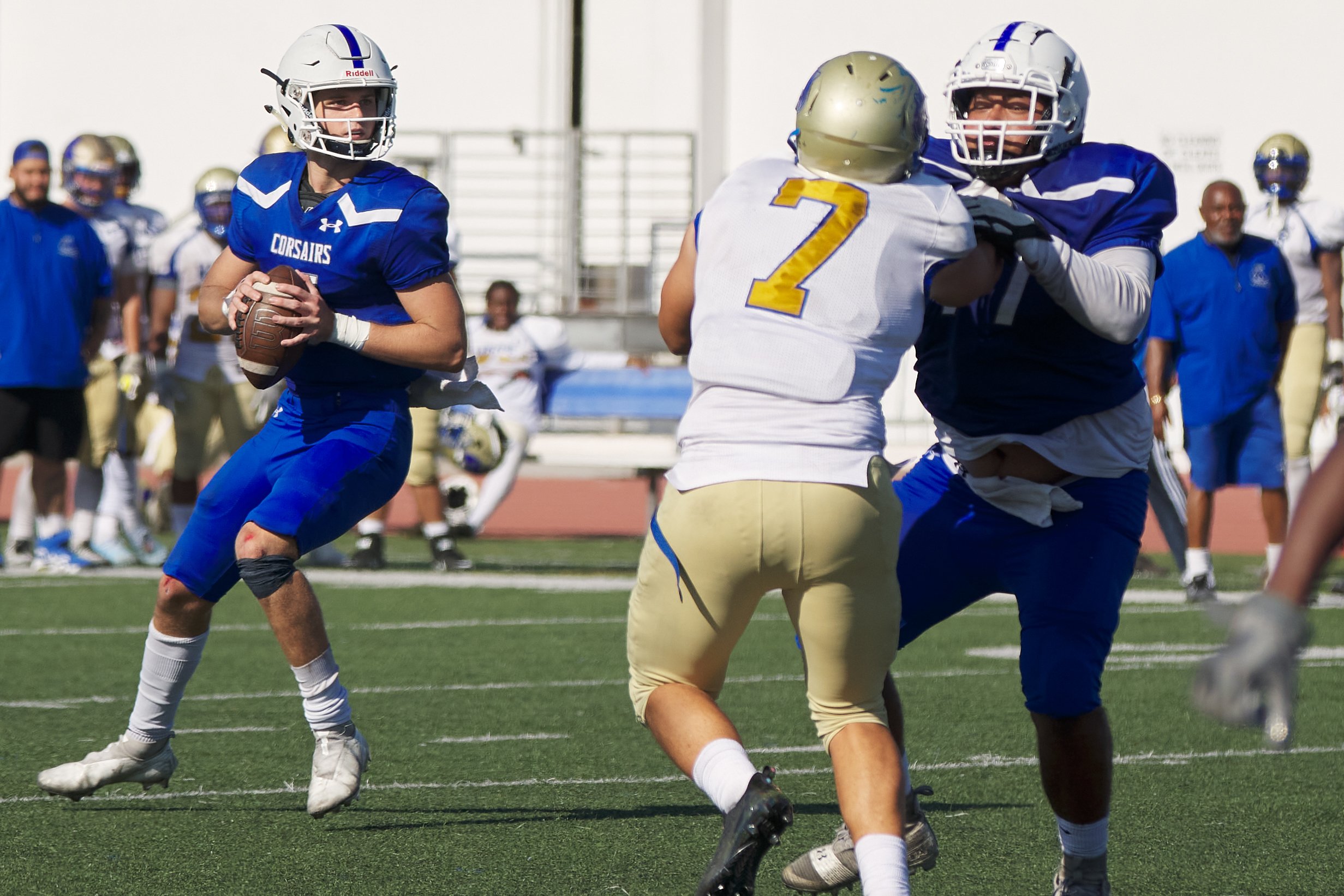  Santa Monica College Corsairs' Forrest Block (left) prepares to throw the ball while Carlos Orea (right) defends him from West Los Angeles College Wildcats' Christopher Gonzales (center) during the football match on Saturday, October 1, 2022, at Cor
