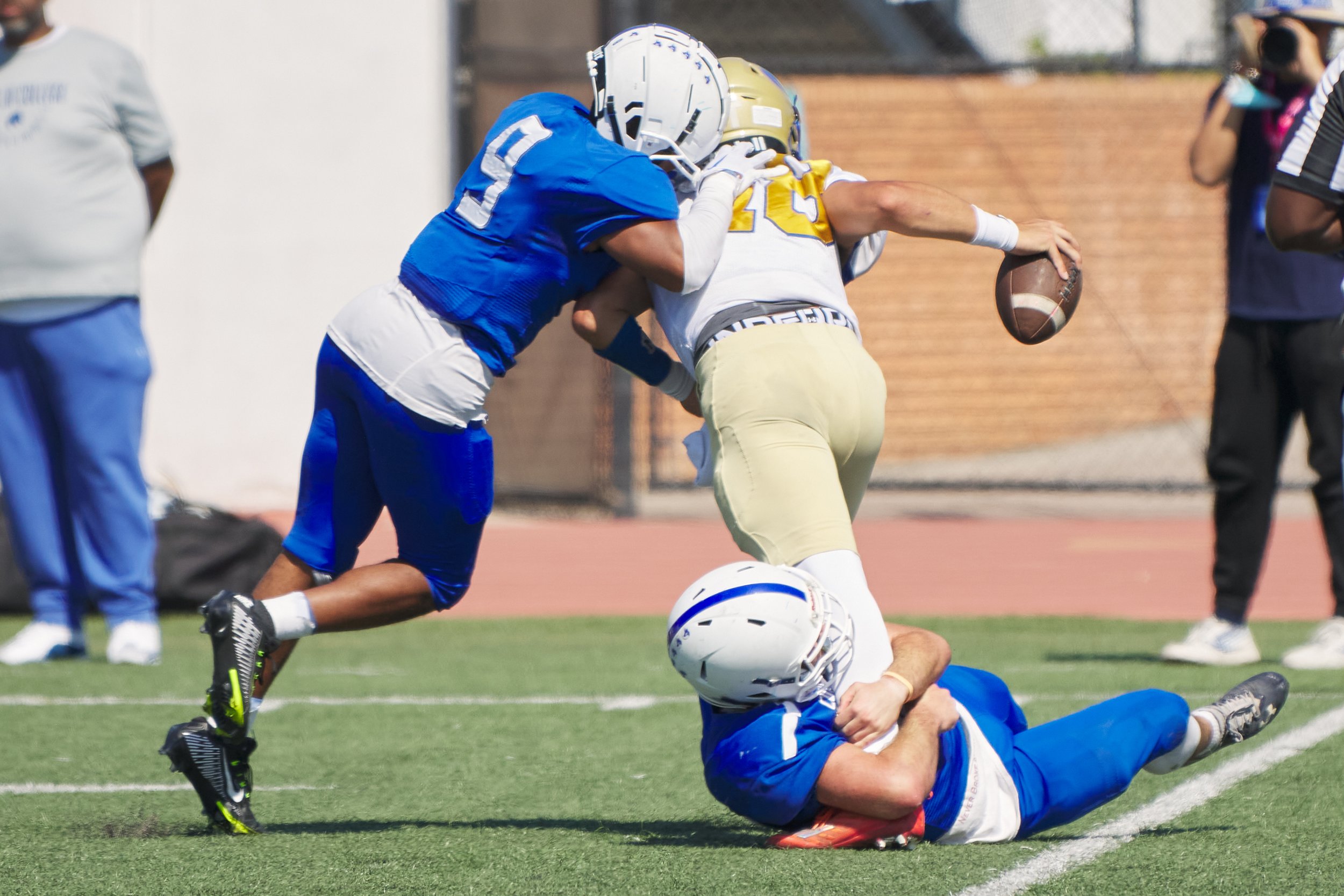  Santa Monica College Corsairs' Kylan Keeler holds on to West Los Angeles Wildcats' David Oliveros so that fellow Corsair Kayden Thomas can attack during the football match on Saturday, October 1, 2022, at Corsair Field in Santa Monica, Calif. The Co