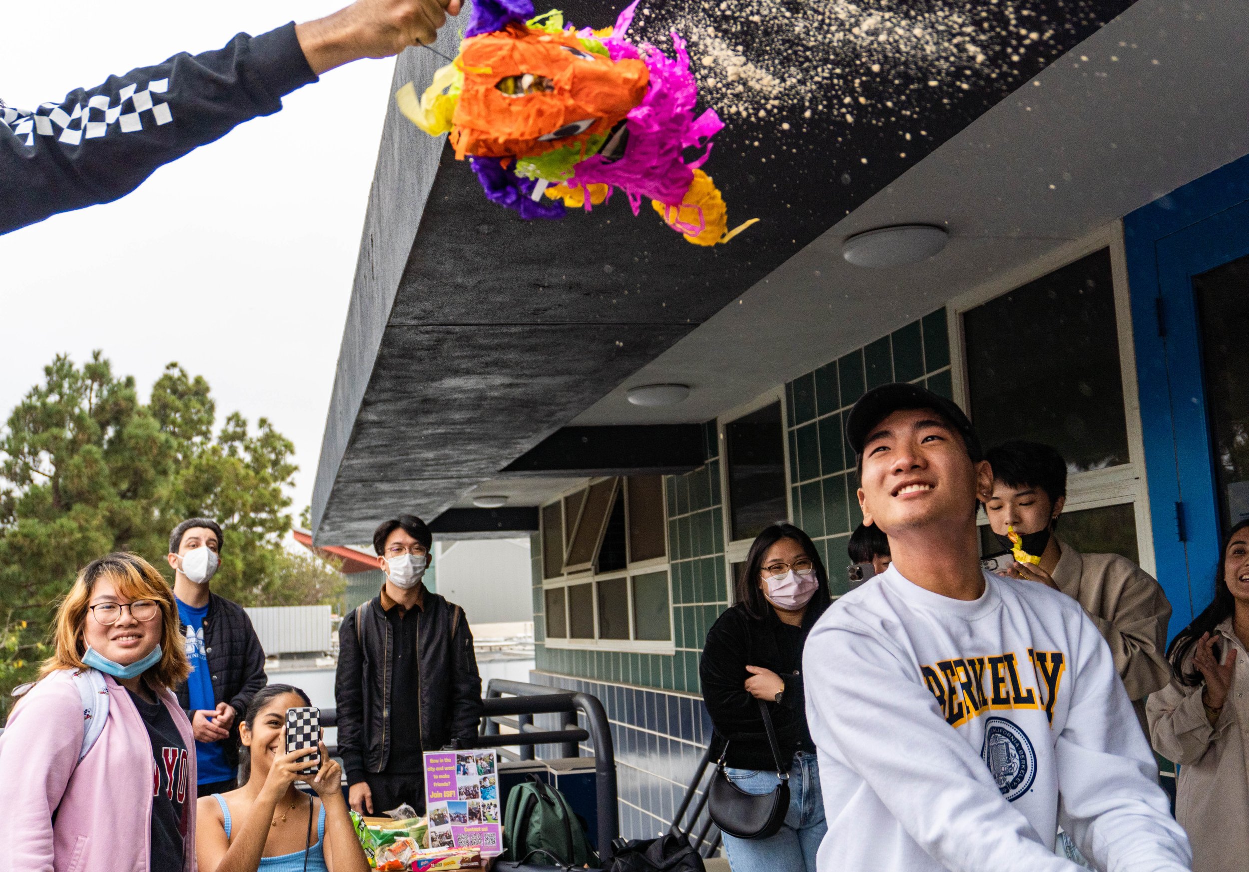  Traves Lee smashes open a piñata during Snacks Appreciation Day, on Oct. 5, 2022. Snacks Appreciation Day was created by the International Student Forum of Santa Monica College to connect SMC international students and allow them a chance to exchang