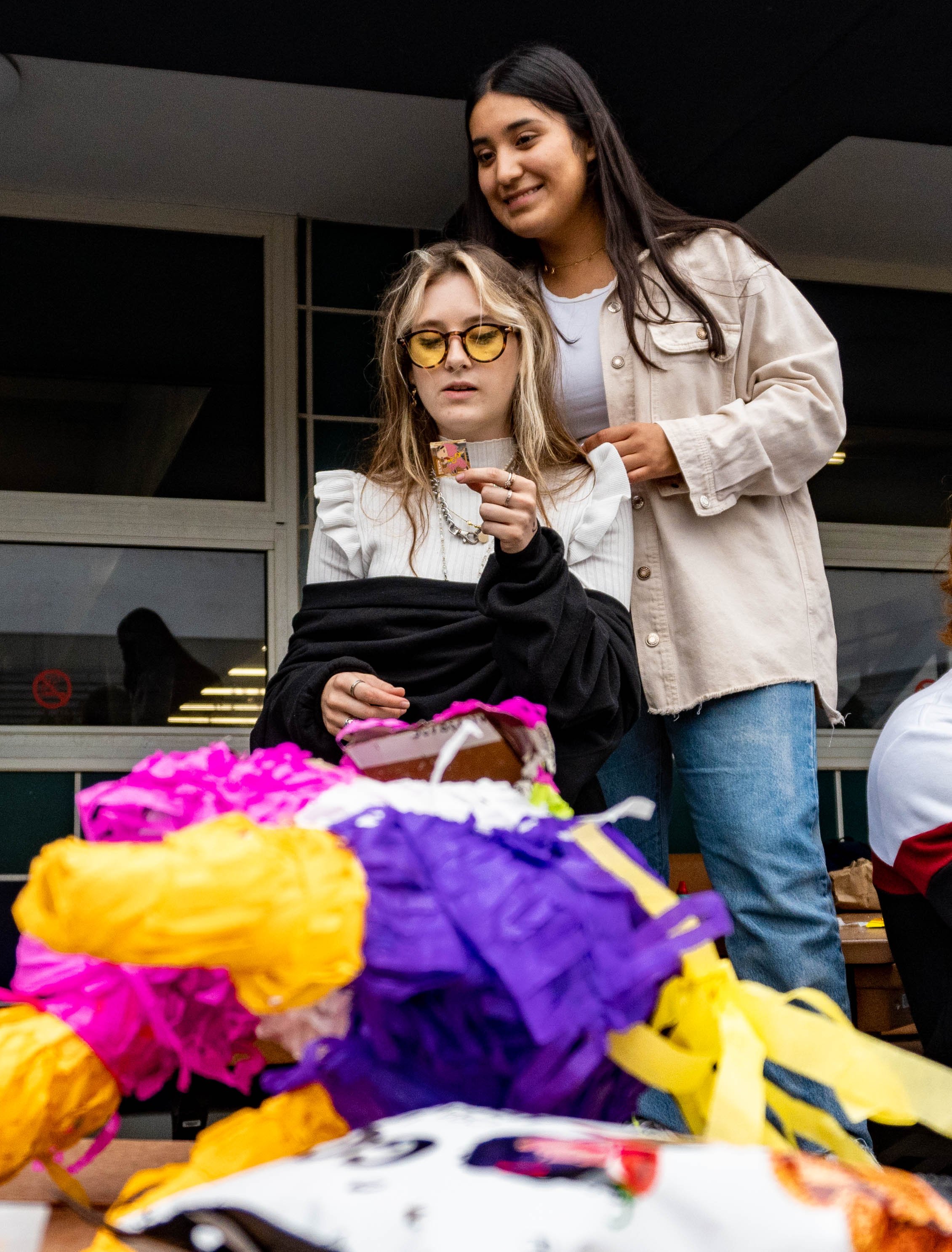  Abril Olivares Nolasco, President of the Santa Monica College International Student Forum (ISF) stands with ISF member Andrea Giraldo in front of the broken pinata during Snacks Appreication Day on Oct. 5, 2022. Santa Monica, Calif. (Ee Lin Tsen | T
