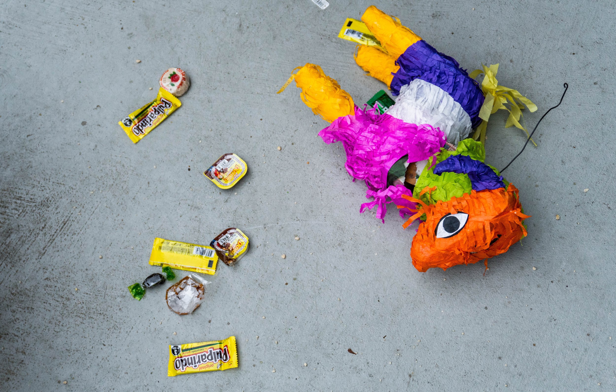  After rounds of being smashed, the piñata showers the floor with well-known Mexican treats like Pulparindo and Duvalin during  Snacks Appreication Day on Oct. 5, 2022. The event was organized by the Santa Monica College International Student Forum i